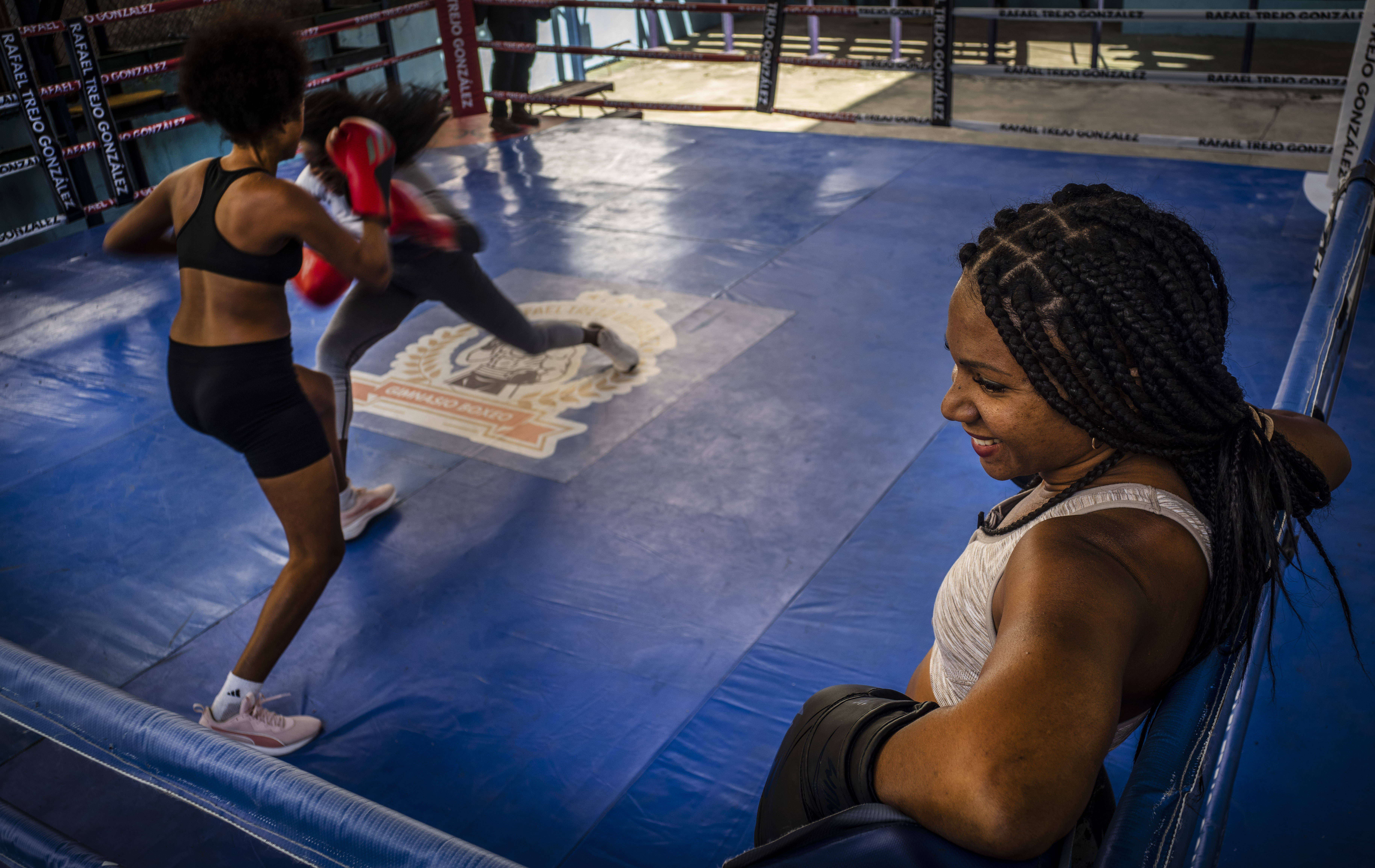 Ydamelys Moreno, right, watches as fellow female boxers train in Havana, Cuba, Monday, Dec. 5, 2022. Cuban officials announced on Monday that women boxers would be able to compete for the first time ever. 