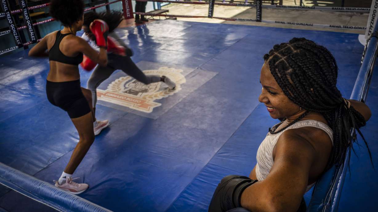 Ydamelys Moreno, right, watches as fellow female boxers train in Havana, Cuba, Monday, Dec. 5, 2022. Cuban officials announced on Monday that women boxers would be able to compete for the first time ever.