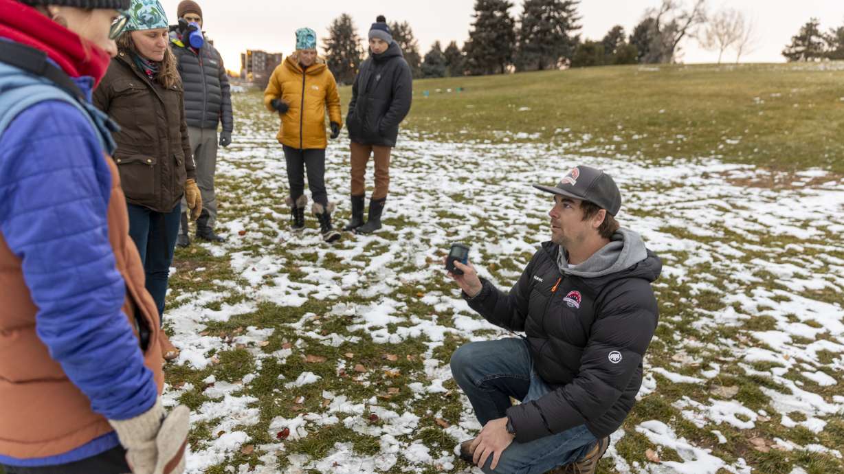 McKinley Talty, of the Utah Avalanche Center, demonstrates how to use a beacon at an event kicking off the fourth annual Avalanche Awareness Week, at Sugar House Park on Monday.