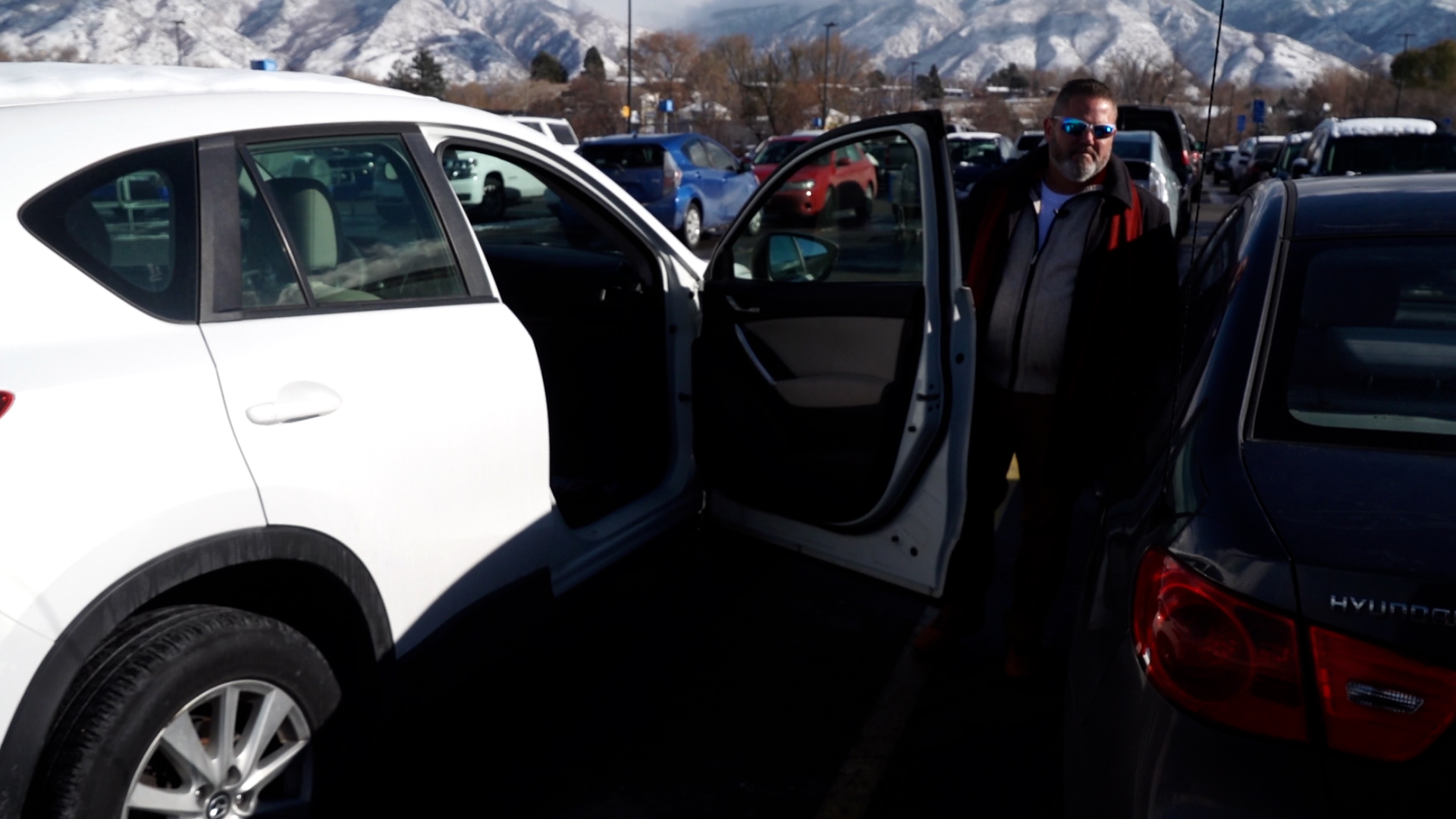 Unified police detective Doug Lambert opens the door of a car left unlocked in a Midvale parking lot.