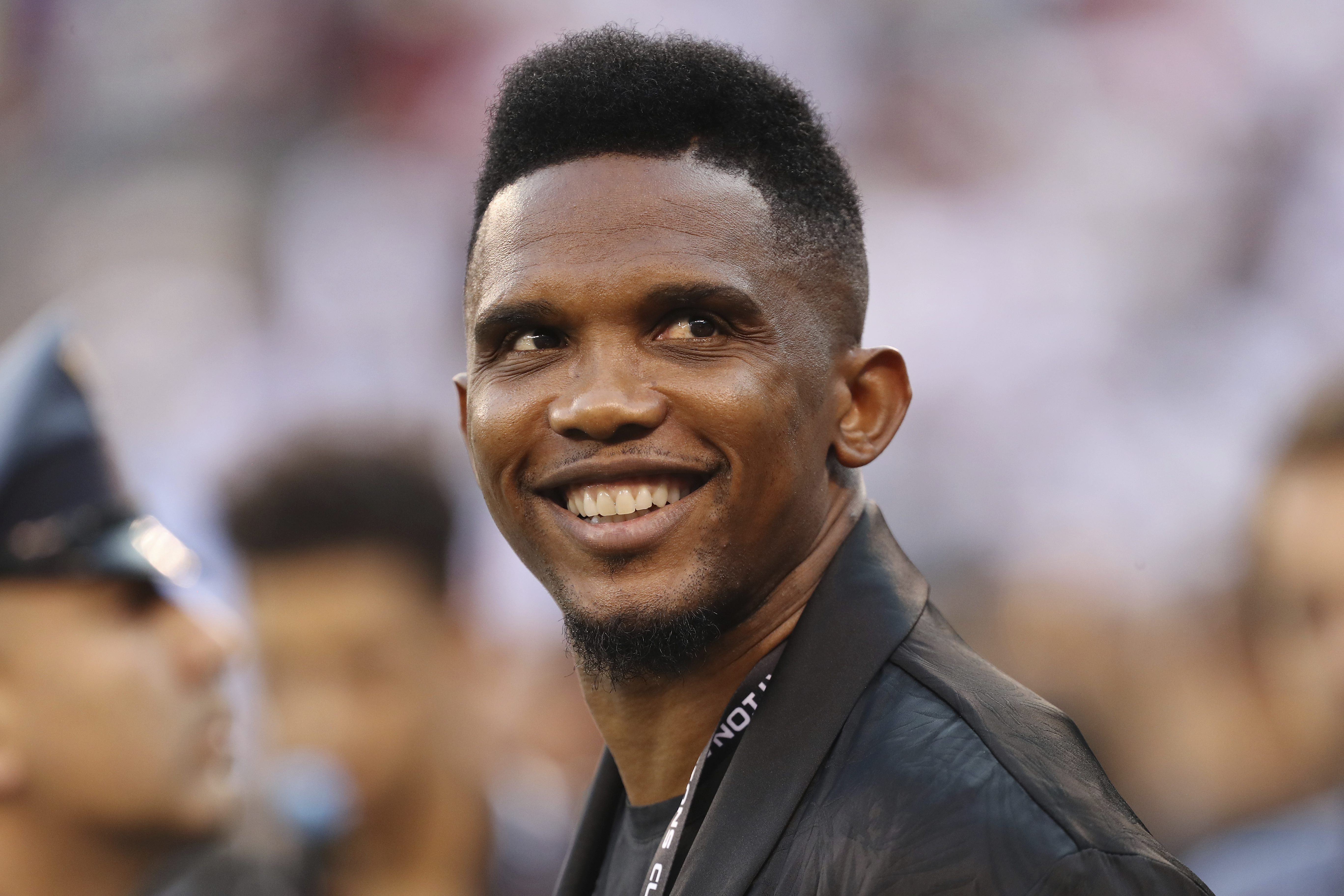 FILE - Soccer player Samuel Eto'o watches warmups before an International Champions Cup soccer match between Atletico Madrid and Real Madrid, Friday, July 26, 2019, in East Rutherford, N.J. Cameroon soccer federation president Samuel Eto'o was filmed apparently kicking a man to the ground in an altercation outside a World Cup stadium early on Tuesday. Eto'o had paused to pose for photos with fans near Stadium 974 after Brazil beat South Korea 4-1. Footage circulating on social media showed him then reacting to comments by a man holding a camera. 