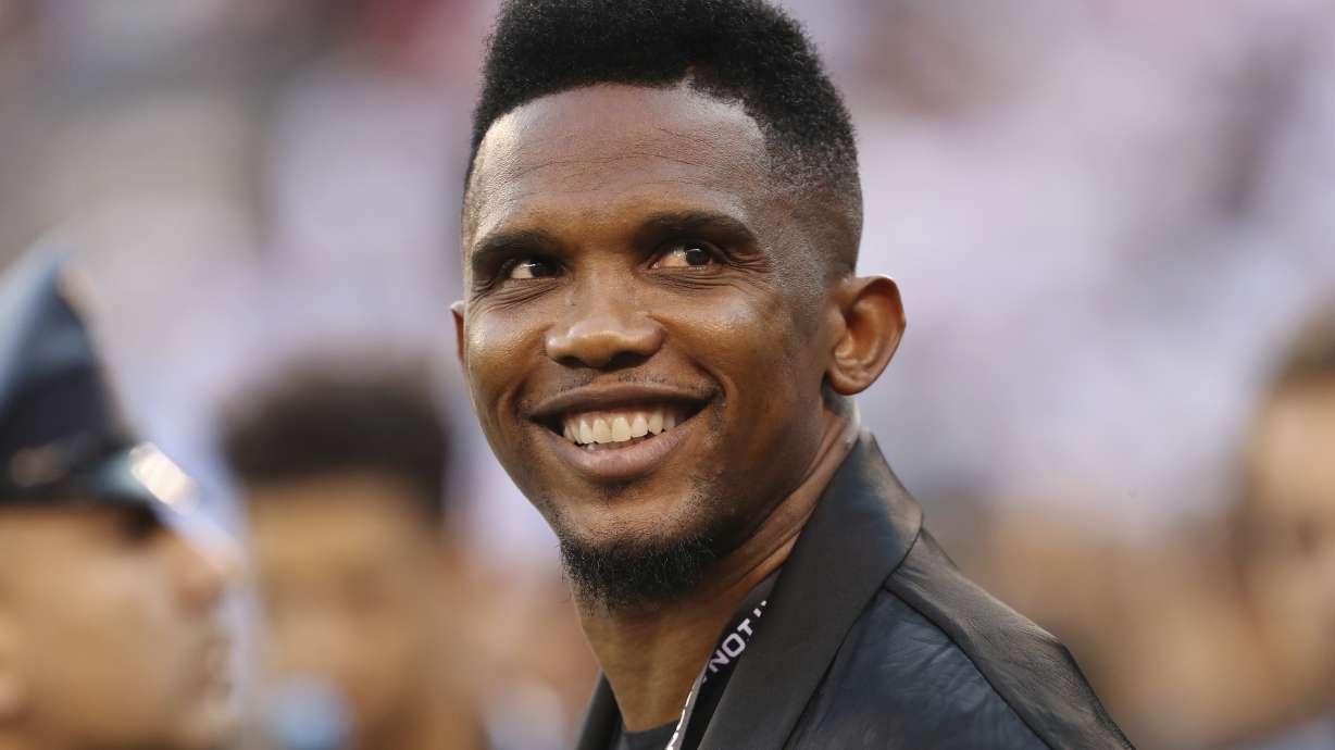 FILE - Soccer player Samuel Eto'o watches warmups before an International Champions Cup soccer match between Atletico Madrid and Real Madrid, Friday, July 26, 2019, in East Rutherford, N.J. Cameroon soccer federation president Samuel Eto'o was filmed apparently kicking a man to the ground in an altercation outside a World Cup stadium early on Tuesday. Eto'o had paused to pose for photos with fans near Stadium 974 after Brazil beat South Korea 4-1. Footage circulating on social media showed him then reacting to comments by a man holding a camera.