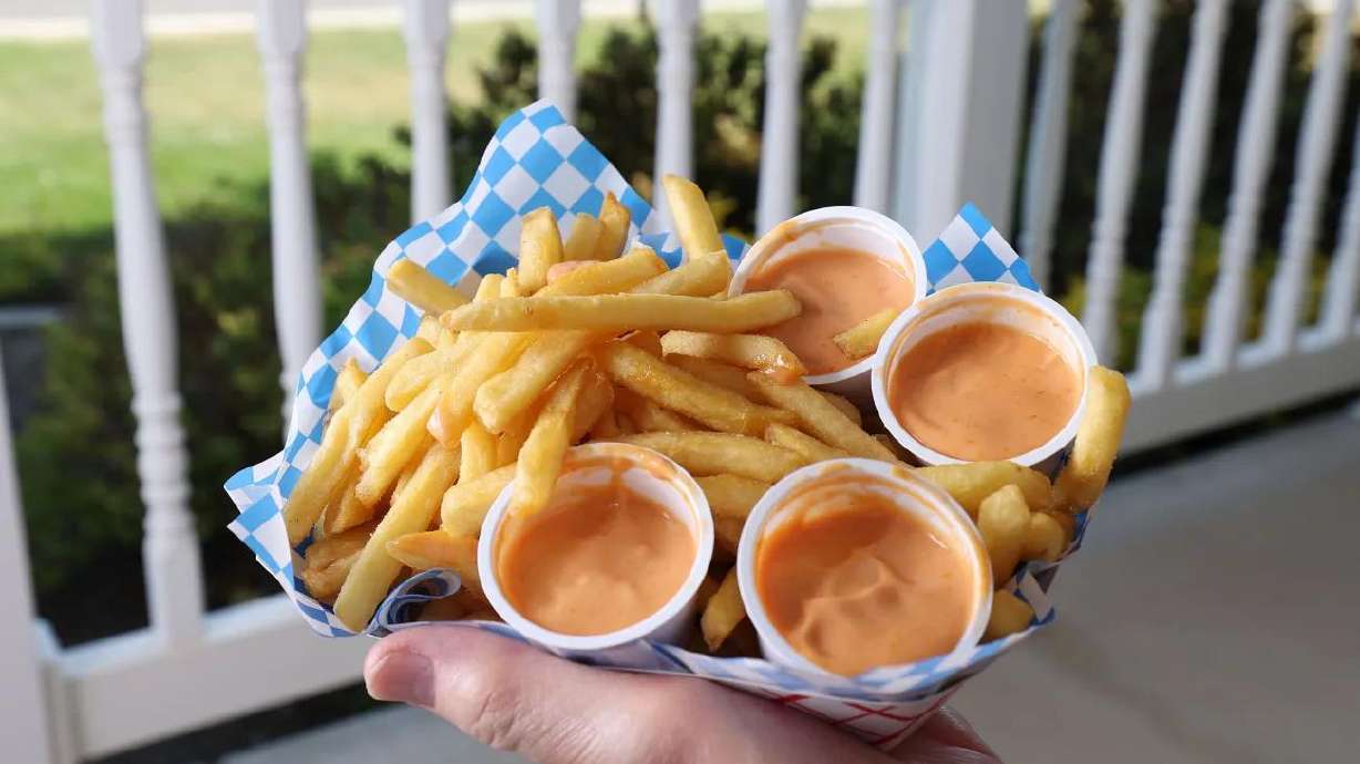 Ron Taylor holds Arctic Circle fries and fry sauce at his home in Orem on June 16.