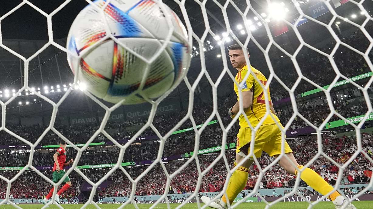 Spain's goalkeeper Unai Simon looks round after Morocco's Achraf Hakimi scored the winning penalty during a shootout after the World Cup round of 16 soccer match between Morocco and Spain, at the Education City Stadium in Al Rayyan, Qatar, Tuesday, Dec. 6, 2022.