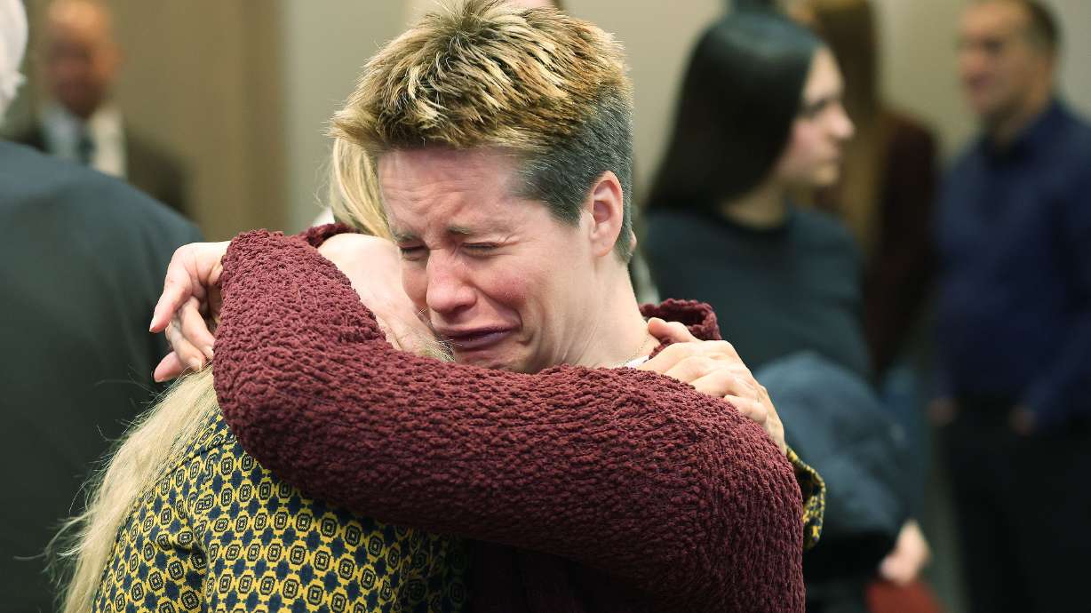 Annie Ferrin is emotional as she hugs a family friend after an apology to their family from the state of Utah on behalf of her mother, Valarie Clark Miller, in Salt Lake City on Tuesday.