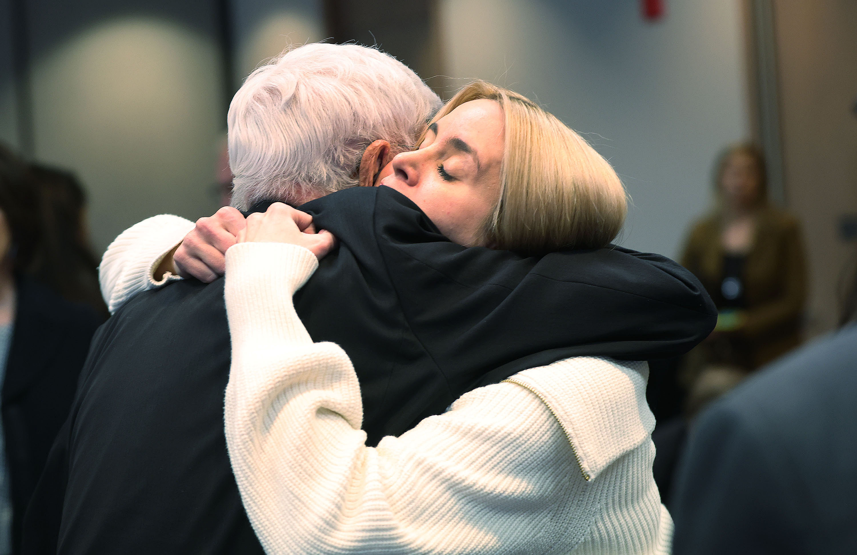 Brooke Jacobs hugs her grandfather Denzel Clark after an apology to their family on behalf of her mother, Valarie Clark Miller, was received from the state of Utah on behalf of her mother in Salt Lake City on Dec. 6, 2022.