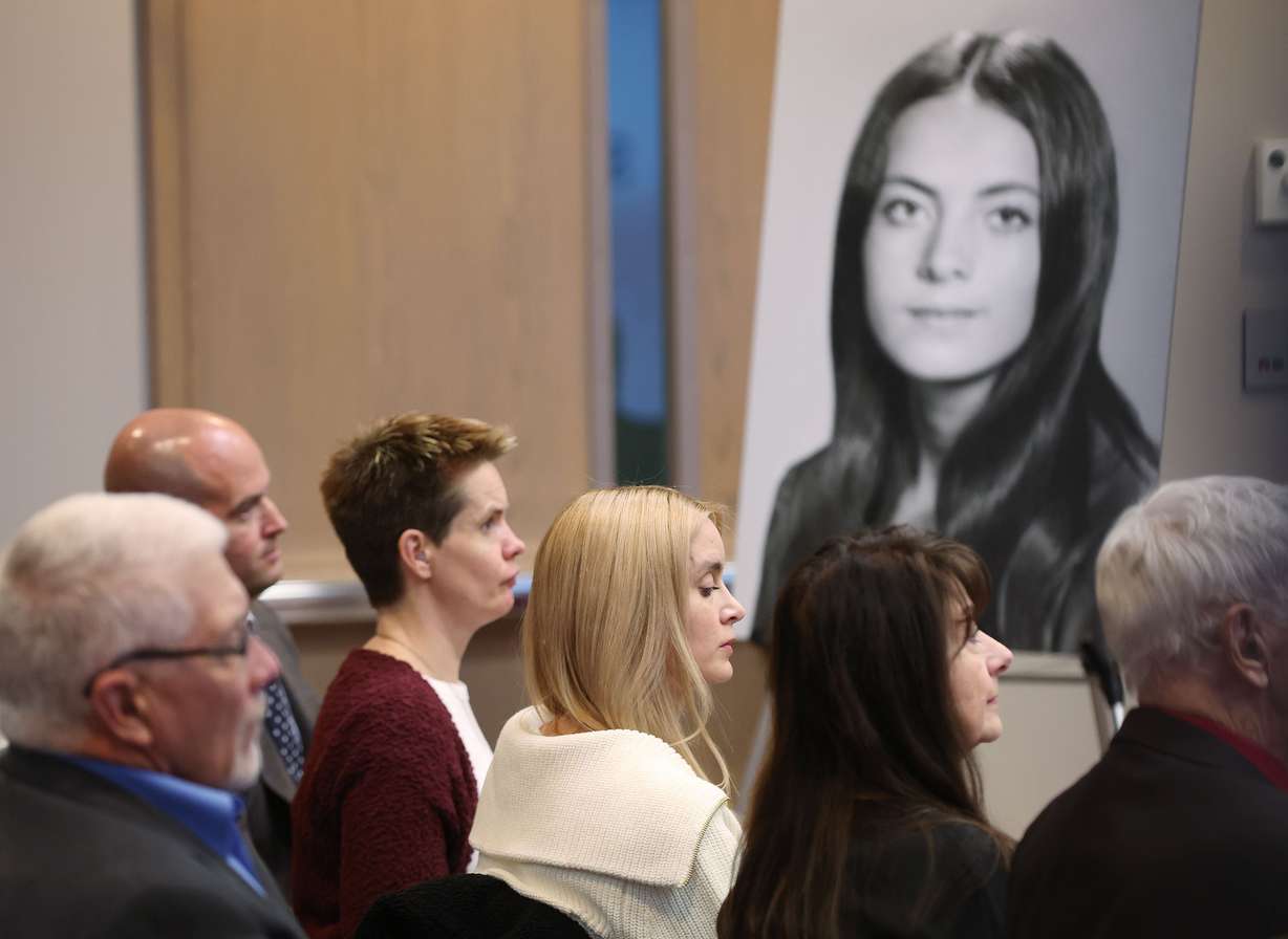 A photo of Valarie Miller hangs near her children during a press conference about the apology the family received from the state of Utah, in Salt Lake City on Tuesday.