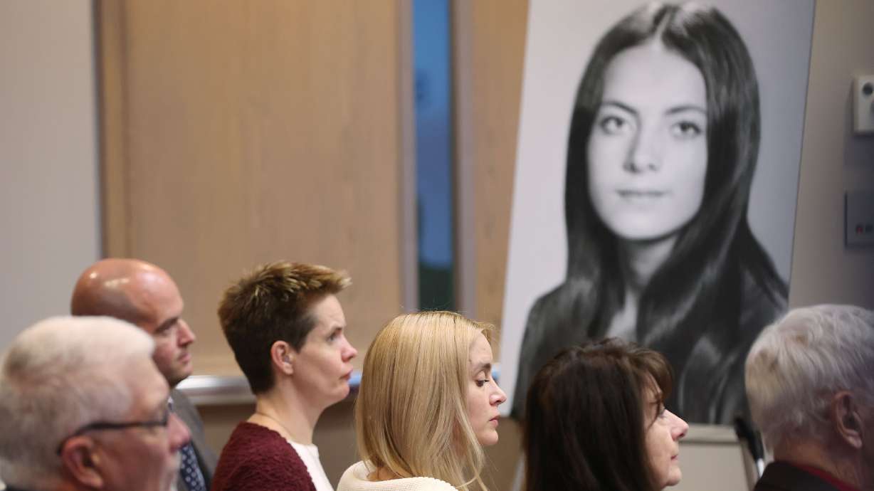 A photo of Valarie Miller hangs near her children who received an apology from the state of Utah on Dec. 6, 2022. Two years after the family exposed a cover-up by state police regarding Miller's sexual assault as a child, a book with more details into her story is being released.