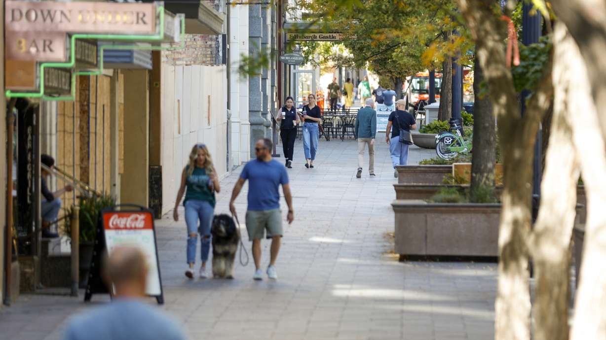 People walk on a sidewalk in Salt Lake City on Oct. 10. Salt Lake City Downtown Alliance leaders say leisure visits to downtown Salt Lake City are inching close to pre-pandemic levels, while office worker stays are still only 54% of levels in 2019.