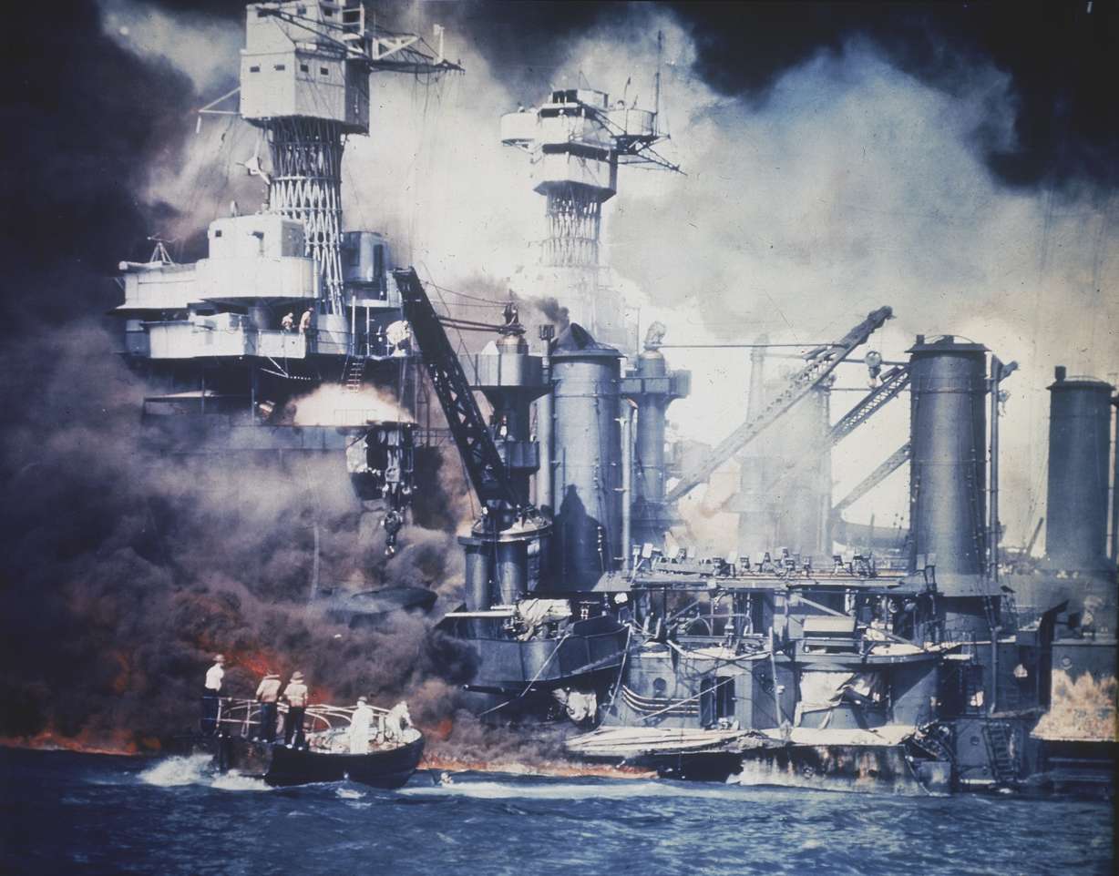 A small boat rescues a USS West Virginia crew member from the water after the Japanese bombing of Pearl Harbor, Hawaii, on Dec. 7, 1941.