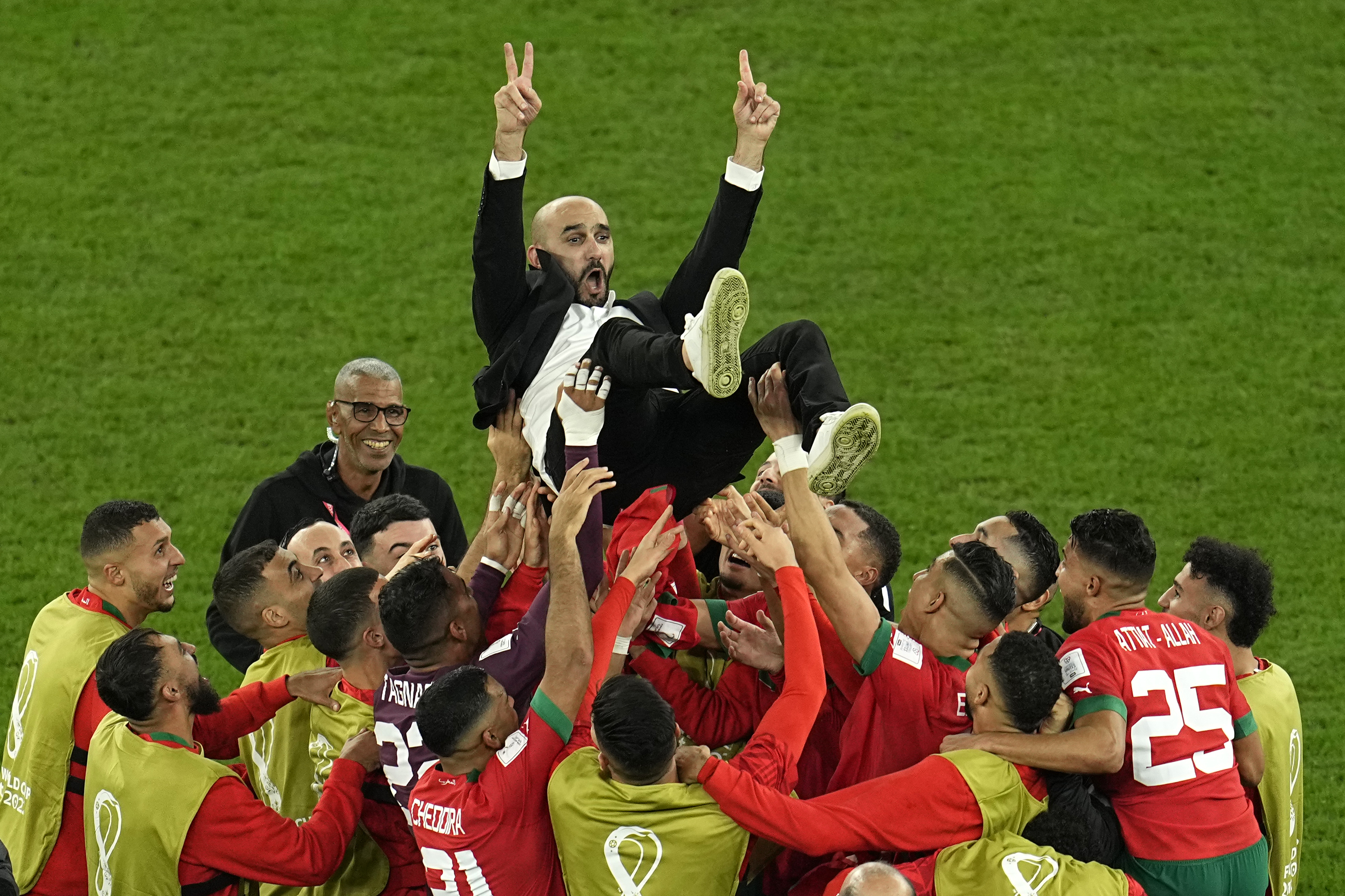 Morocco's head coach Walid Regragui is thrown in the air at the end of the World Cup round of 16 soccer match between Morocco and Spain, at the Education City Stadium in Al Rayyan, Qatar, Tuesday, Dec. 6, 2022.