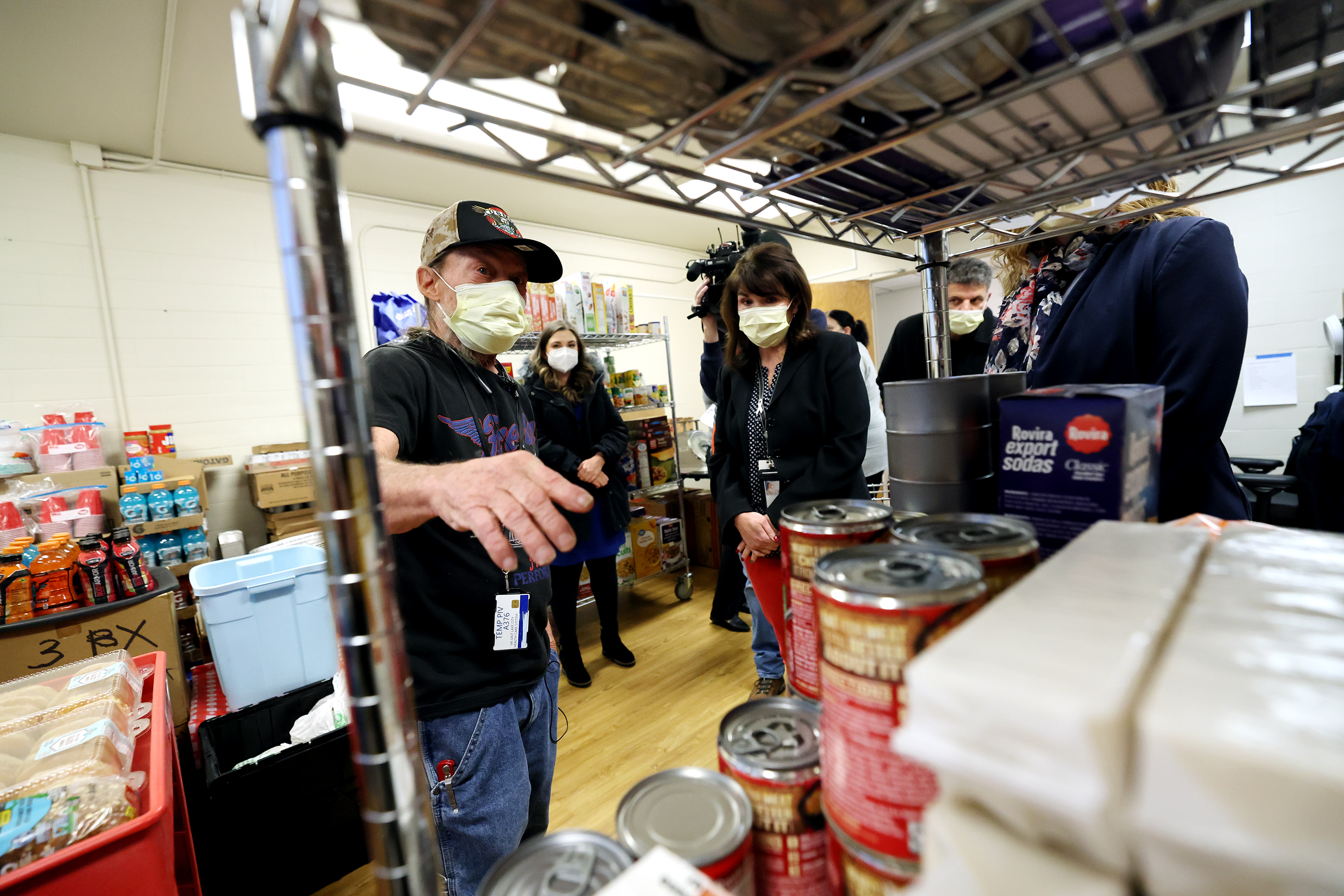 Rex Randall, a Marine veteran and pantry worker, shows Shelly Granger, acting deputy nurse executive, and Nova Reddick-Starkel, associate director, the different sections of the pantry as the VA Salt Lake City Health Care System opened its new food pantry in Building 5 at the George E. Wahlen VA Medical Center in Salt Lake City on Wednesday.