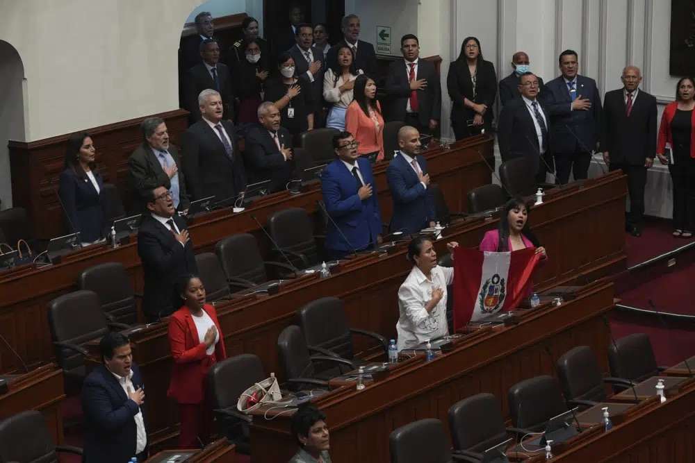 Lawmakers sing their national anthem inside Congress after Peruvian President Pedro Castillo dissolved the body on the day they were planning an impeachment vote on the president in Lima, Peru, Wednesday. Castillo also called for new legislative elections, before lawmakers could debate a third attempt to remove him from office.