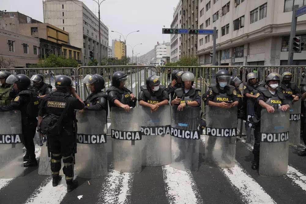 Police block a street that leads to Congress after Peruvian President Pedro Castillo dissolved the body on the day lawmakers planned an impeachment vote on him in Lima, Peru, Wednesday. Castillo dissolved the nation's Congress on Wednesday and called for new legislative elections before lawmakers could debate a third attempt to remove him from office.