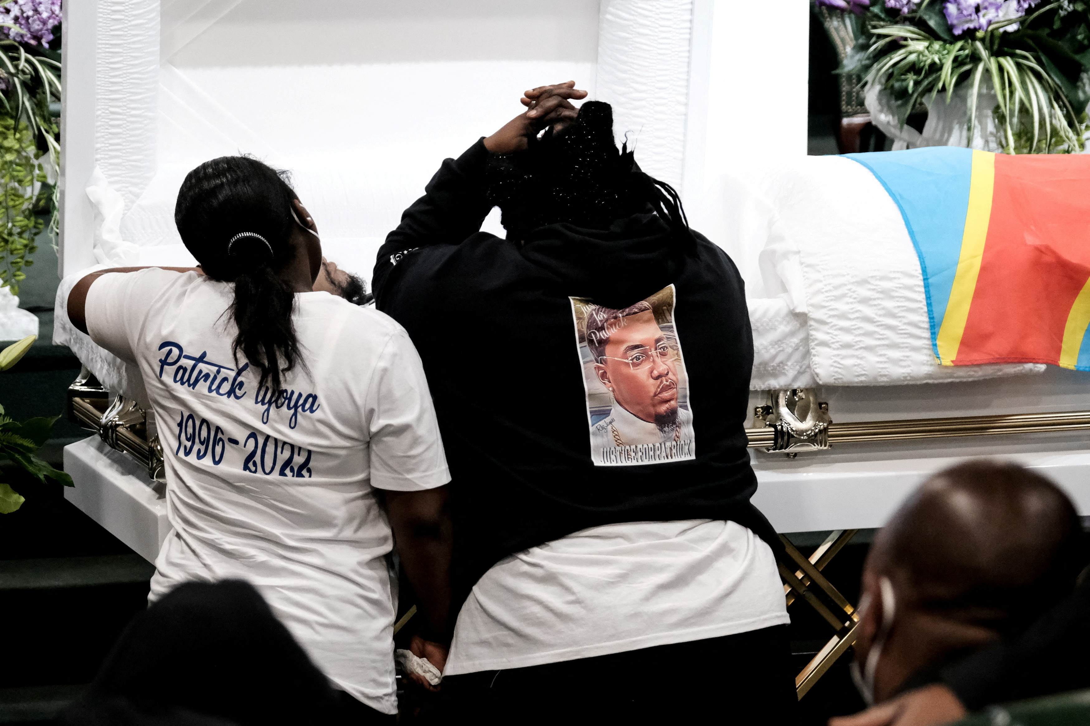 Dorcas Lyoya mourns over the body of her eldest son Patrick Lyoya, an unarmed Black man who was shot and killed by a Grand Rapids Police officer during a traffic stop on April 4, at Renaissance Church of God in Christ in Grand Rapids, Michigan, April 22.