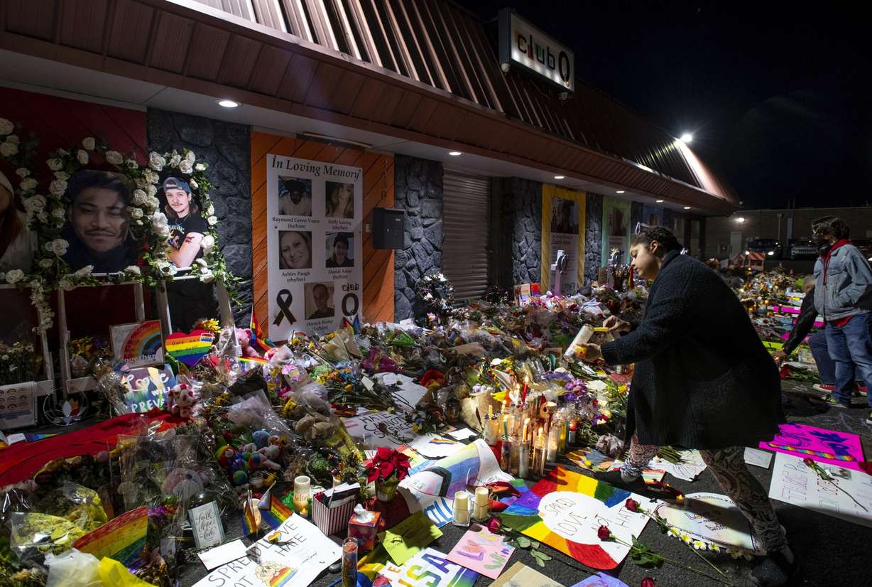 Kebrina Chirdon lights candles at a memorial outside of Club Q on Nov. 25 in Colorado Springs, Colo.
