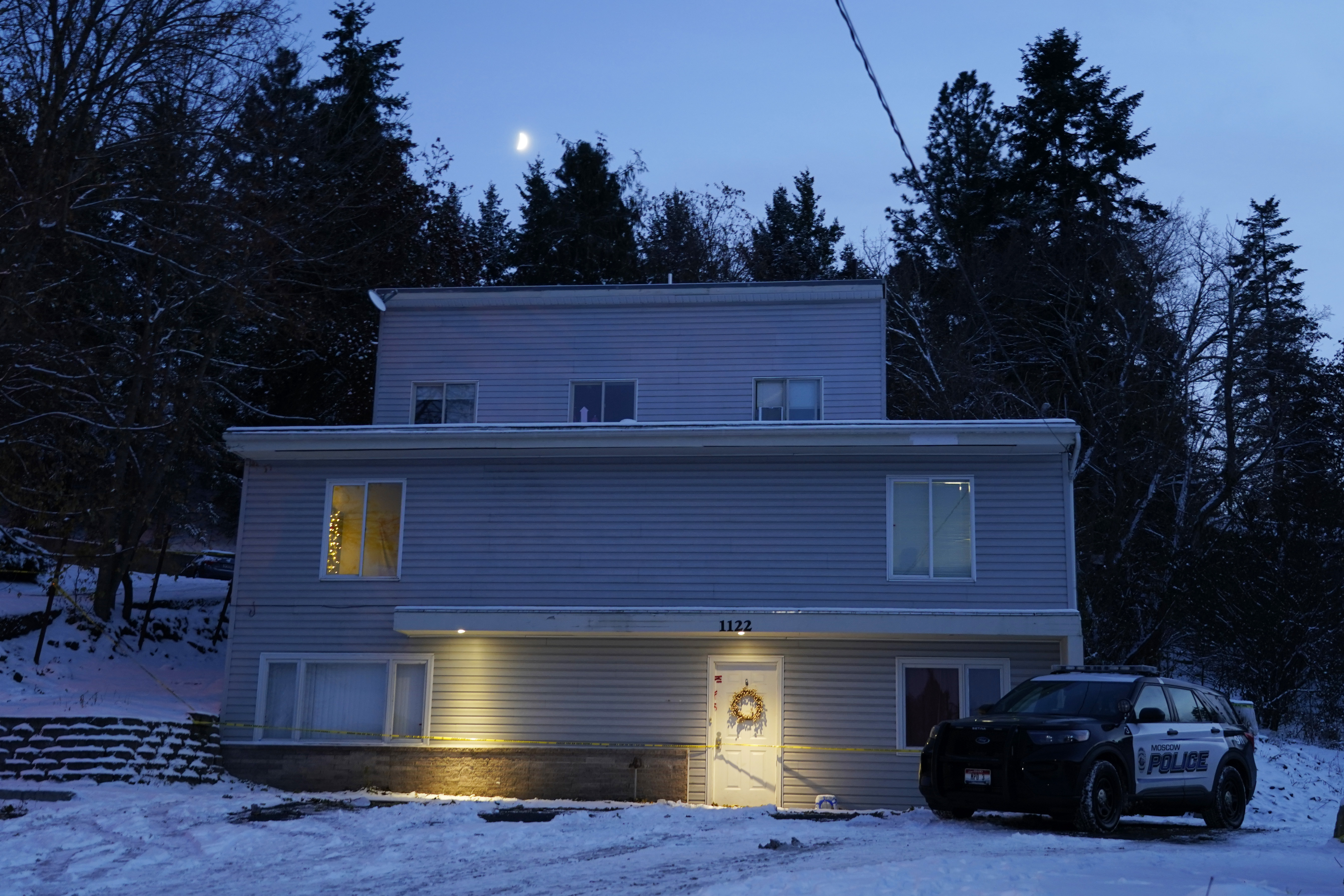 The moon rises on Nov. 29 as a Moscow police officer stands guard in his vehicle at the home where four University of Idaho students were found dead on Nov. 13. It's been nearly three the students were found stabbed to death in a home near campus, but there are still more questions than answers surrounding the investigation.