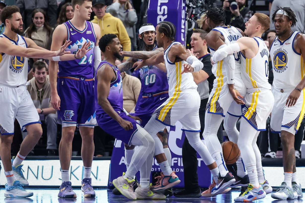 Utah Jazz guard Jordan Clarkson (00) and Golden State Warriors forward Jonathan Kuminga (00) exchange words in the final moments of a game at Vivint Arena in Salt Lake City on Wednesday, Dec. 7, 2022.