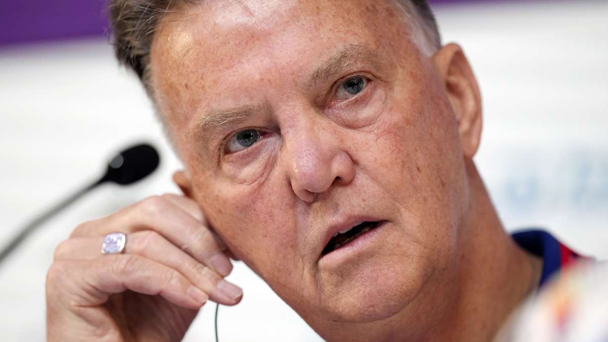 Head coach Louis van Gaal of the Netherlands adjusts his audio device during Netherlands official press conference on the eve of World Cup soccer match between Netherlands and Argentina in Doha, Qatar, Thursday, Dec. 8, 2022.