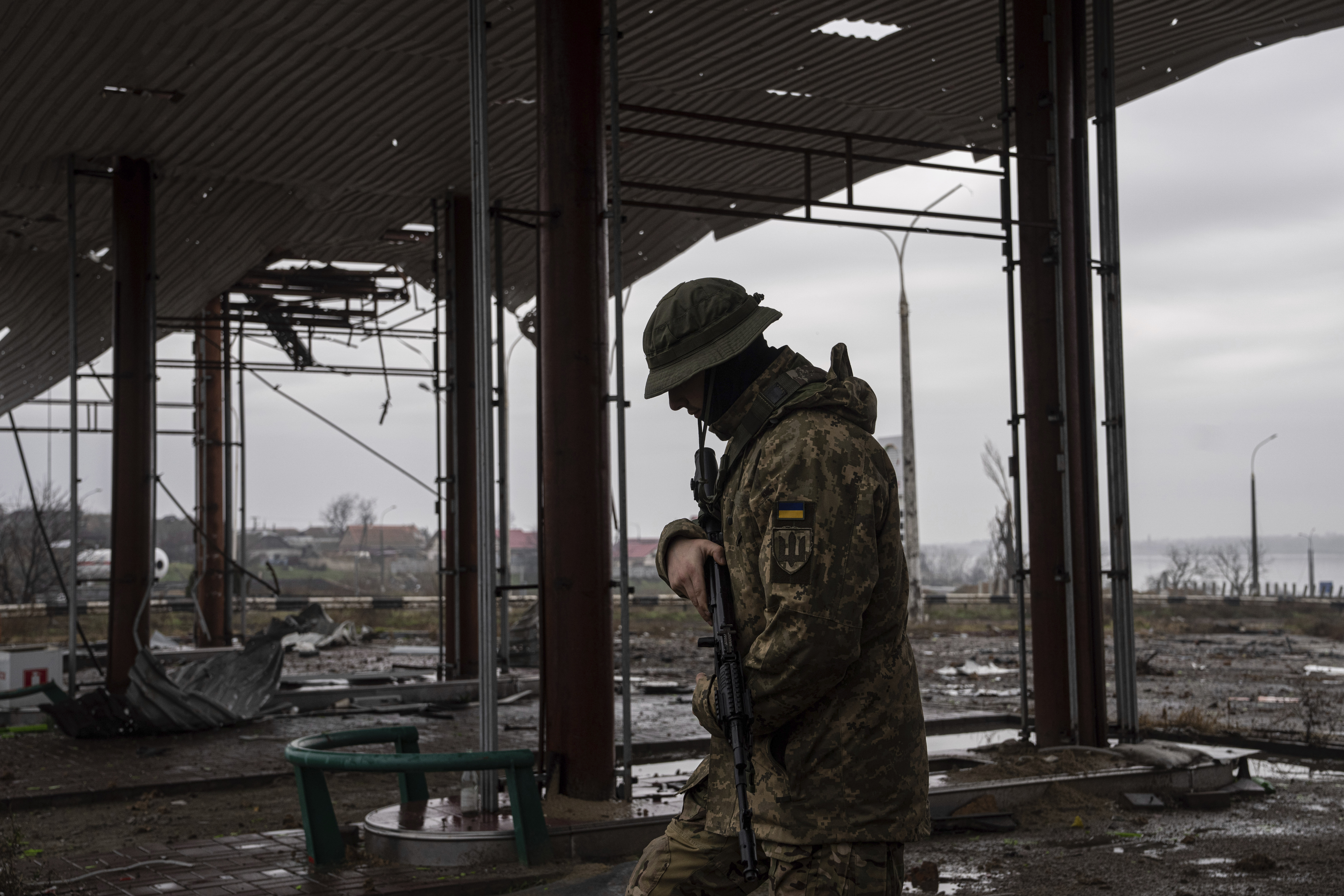 A Ukrainian serviceman patrols area near the Antonovsky Bridge, which was destroyed by Russian forces after withdrawing from Kherson, Ukraine, Thursday. Officials say the U.S. is sending an additional $275 million in military aid to Ukraine.