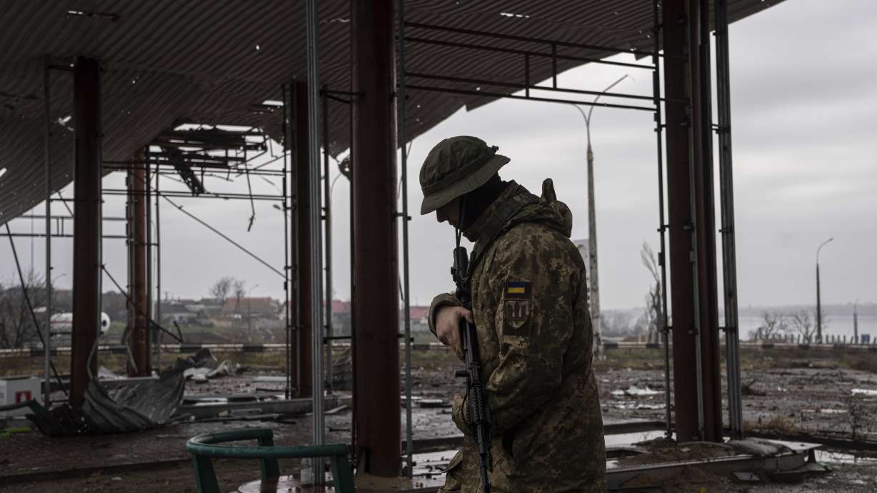A Ukrainian serviceman patrols area near the Antonovsky Bridge, which was destroyed by Russian forces after withdrawing from Kherson, Ukraine, Thursday. Officials say the U.S. is sending an additional $275 million in military aid to Ukraine.