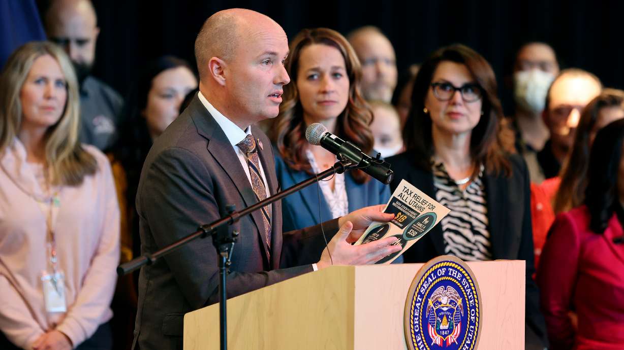 Gov. Spencer Cox, surrounded by teachers, education administrators and community council members, announces his fiscal year 2024 budget recommendations, which include salary raises for teachers, at Centennial Junior High School in Kaysville on Thursday.