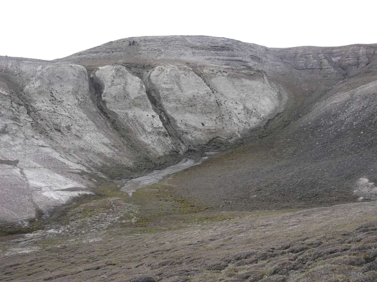 This 2006 photo provided by researchers shows geological formations at Kap Kobenhavn, Greenland. The two people at the top are sampling for environmental DNA.