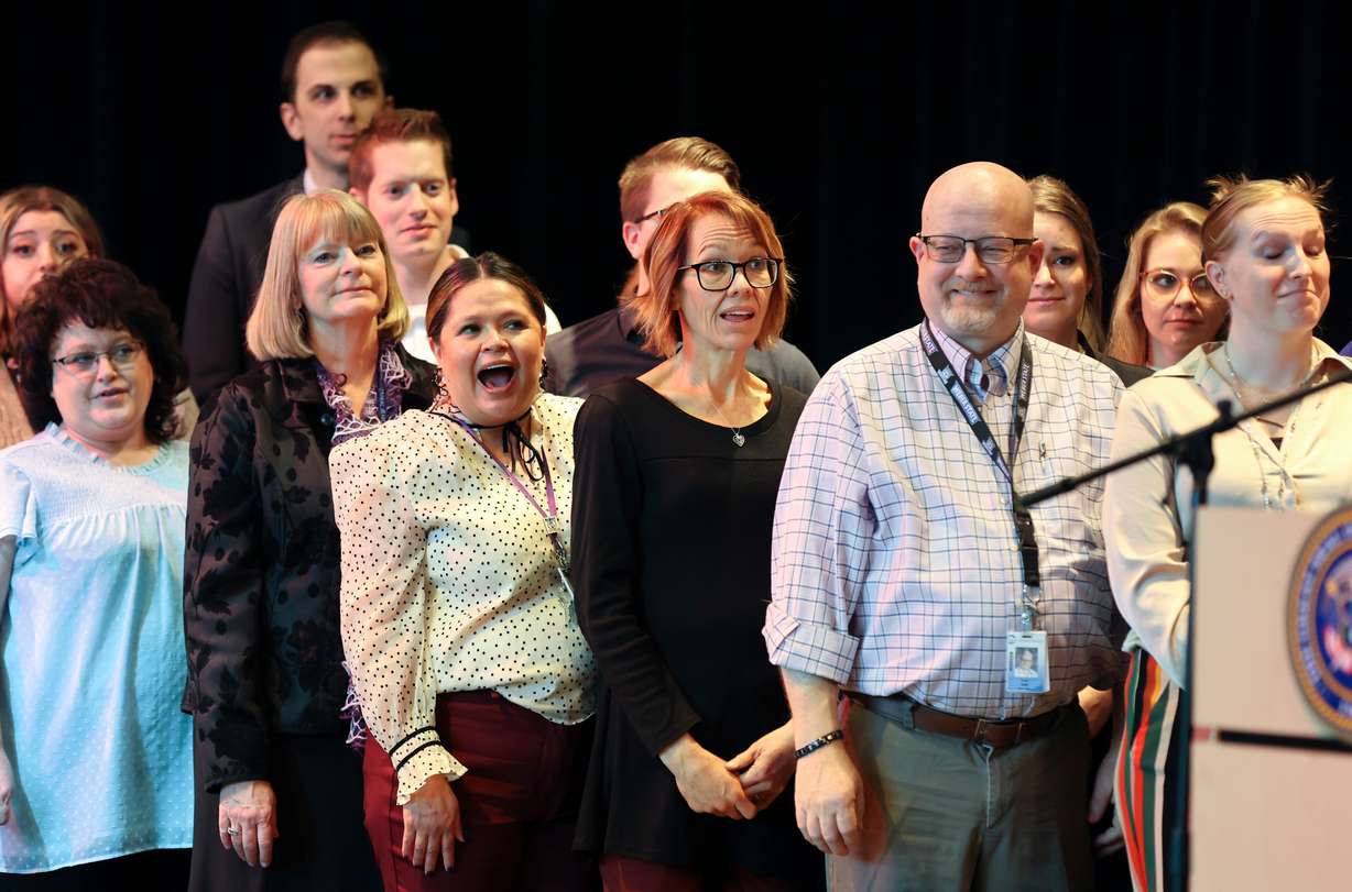 Teachers, education administrators and community council members react as Gov. Spencer Cox announces that his fiscal year 2024 budget recommendations will include salary raises for educators at Centennial Junior High School in Kaysville on Thursday.
