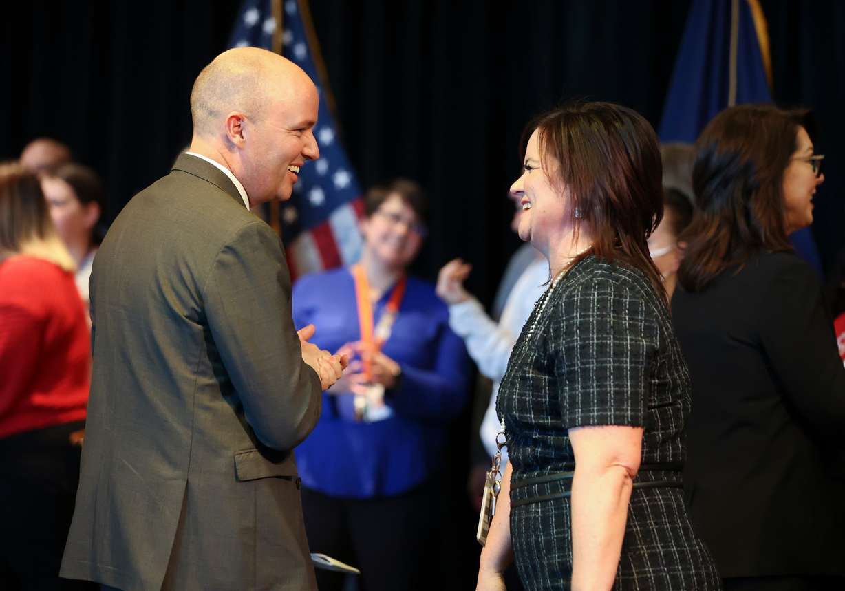 Gov. Spencer Cox speaks to Centennial Junior High School Principal Merci Rossmango before announcing his fiscal year 2024 budget recommendations, which include salary raises for educators, at Centennial Junior High School in Kaysville on Thursday.