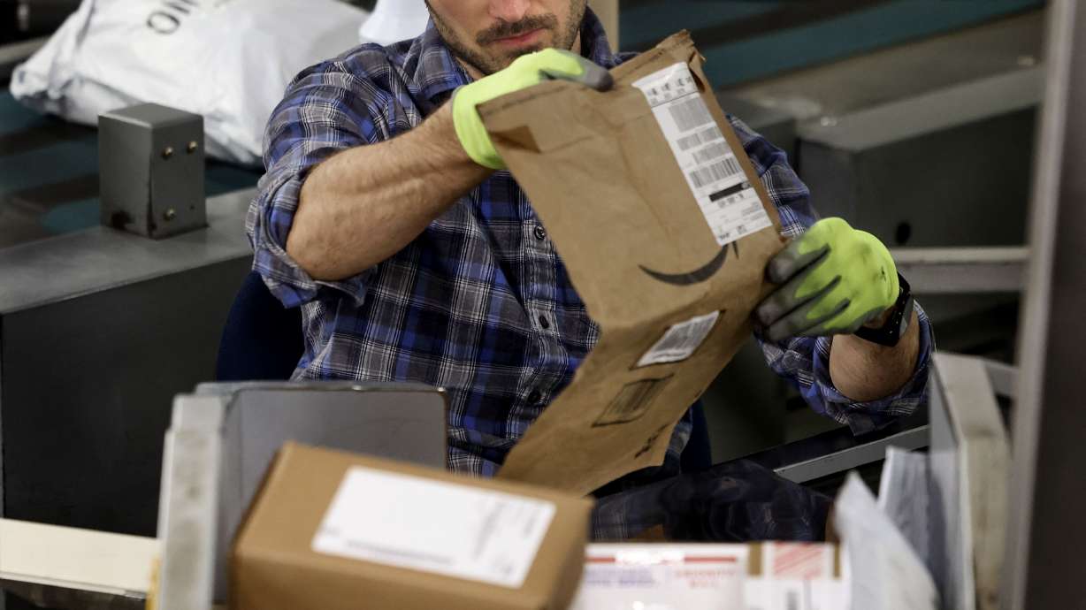 Bryan Freeborn works at one of the package sorting machines at the United States Postal Service Priority Mail Center in Salt Lake City on Thursday.