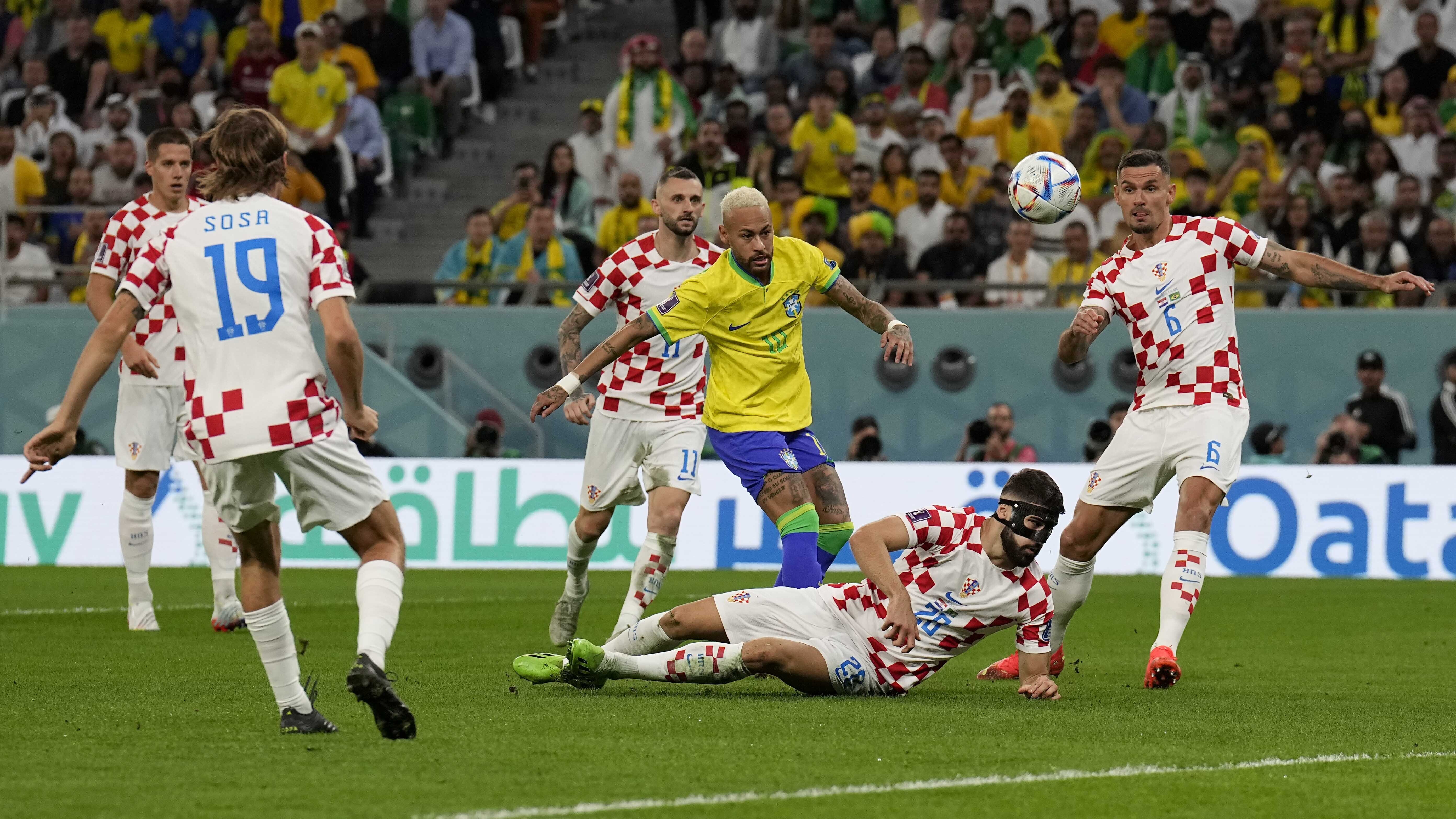 Brazil's Neymar, center, kicks the ball besides Croatia's Josko Gvardiol, bottom, Croatia's Dejan Lovren, right, Croatia's Marcelo Brozovic, background, and Croatia's Borna Sosa, left, during the World Cup quarterfinal soccer match between Croatia and Brazil, at the Education City Stadium in Al Rayyan, Qatar, Friday, Dec. 9, 2022. 