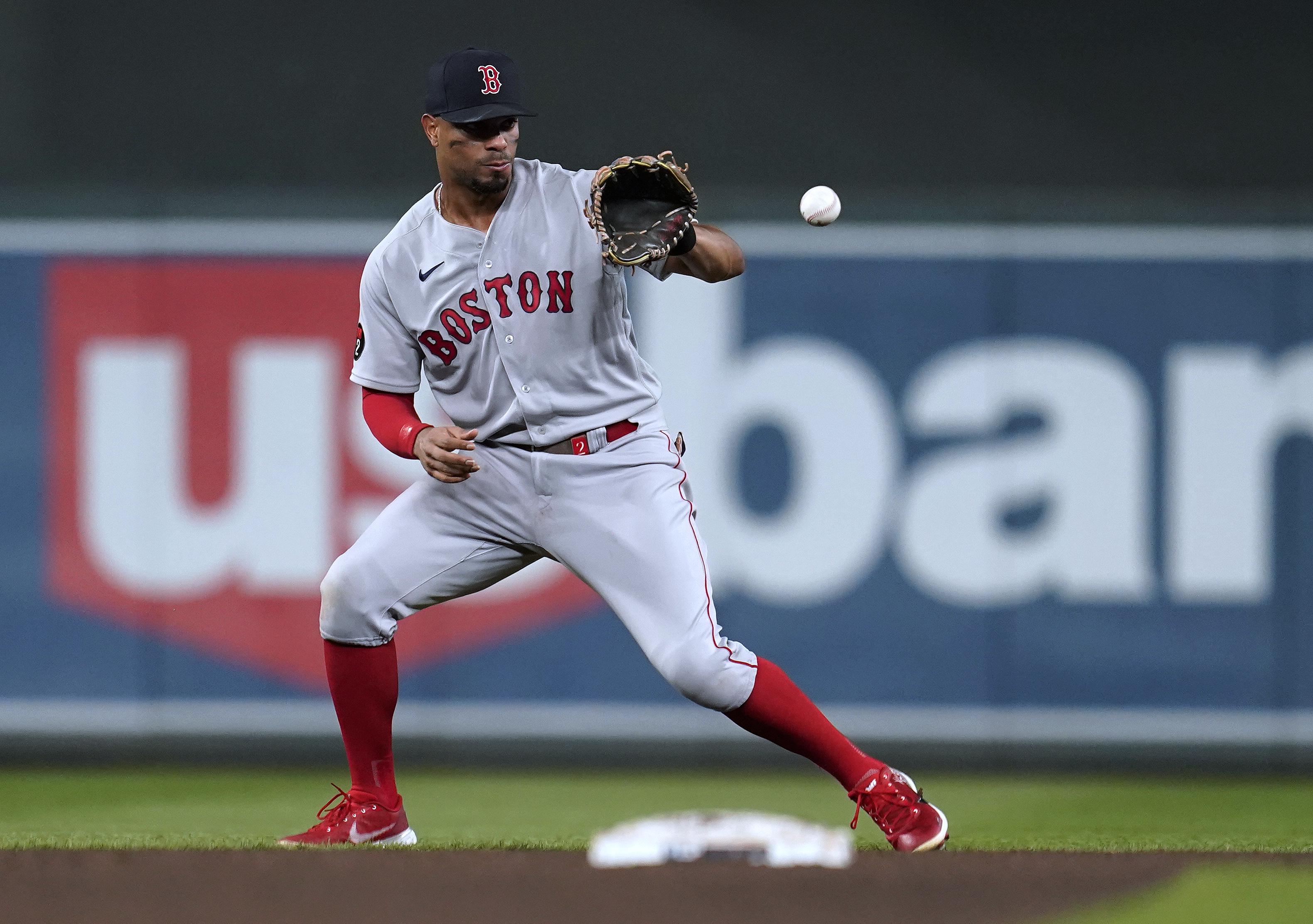 FILE - Boston Red Sox's Xander Bogaerts fields the ball hit by Minnesota Twins' Luis Arraez during the fifth inning of a baseball game Aug. 31, 2022, in Minneapolis. The San Diego Padres and Bogaerts agreed to a blockbuster $280 million, 11-year contract Wednesday night, Dec. 7, adding the All-Star slugger to an already deep lineup. A person familiar with the negotiations confirmed the contract to The Associated Press on condition of anonymity because it was pending a physical. 