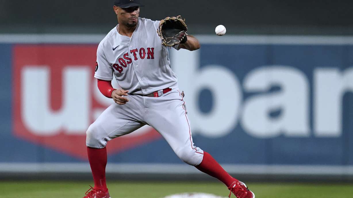 FILE - Boston Red Sox's Xander Bogaerts fields the ball hit by Minnesota Twins' Luis Arraez during the fifth inning of a baseball game Aug. 31, 2022, in Minneapolis. The San Diego Padres and Bogaerts agreed to a blockbuster $280 million, 11-year contract Wednesday night, Dec. 7, adding the All-Star slugger to an already deep lineup. A person familiar with the negotiations confirmed the contract to The Associated Press on condition of anonymity because it was pending a physical.