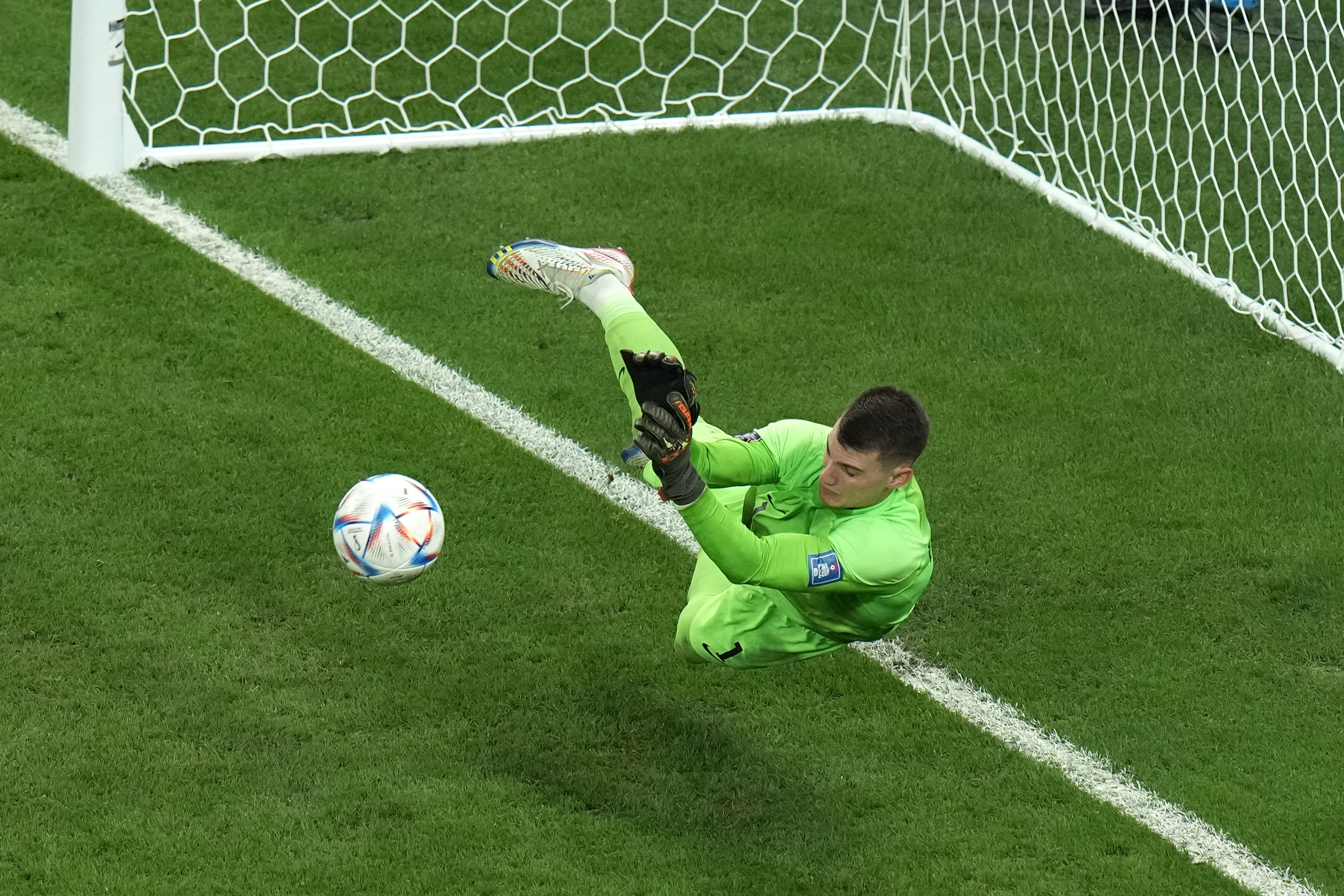 Croatia's goalkeeper Dominik Livakovic saves a ball during the penalty shoot out at the World Cup quarterfinal soccer match between Croatia and Brazil, at the Education City Stadium in Al Rayyan, Qatar, Friday, Dec. 9, 2022. 