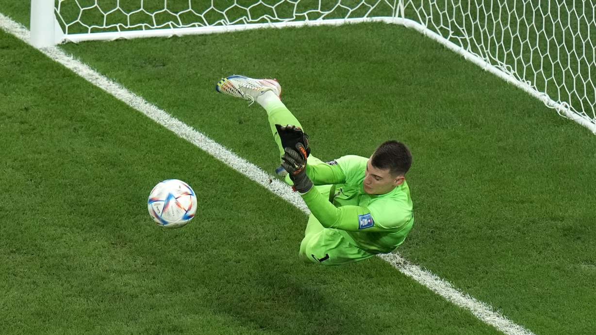 Croatia's goalkeeper Dominik Livakovic saves a ball during the penalty shoot out at the World Cup quarterfinal soccer match between Croatia and Brazil, at the Education City Stadium in Al Rayyan, Qatar, Friday, Dec. 9, 2022.