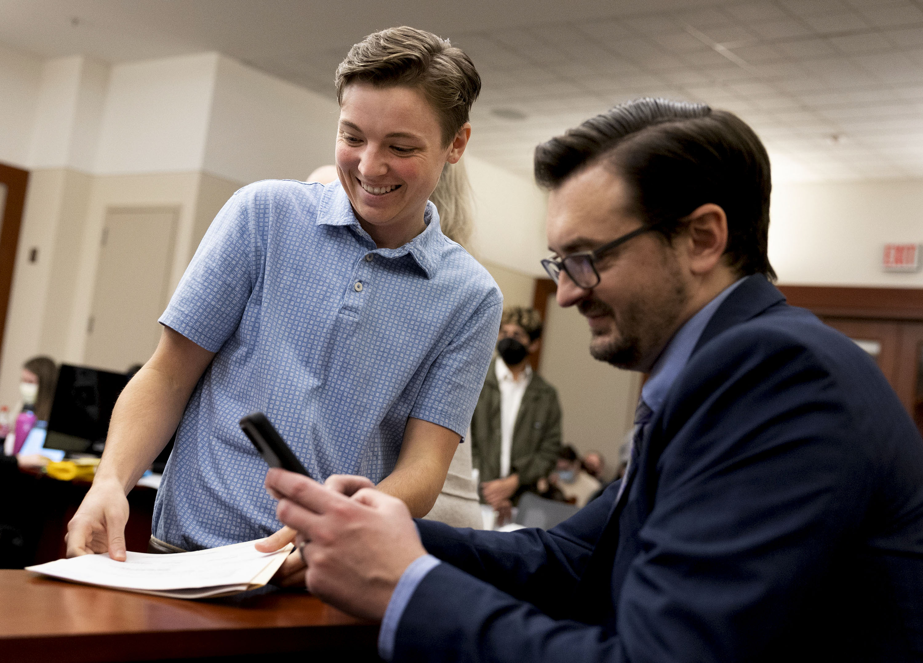 Jaxon Smith, left, works on his paperwork with attorney Derek Parry during Gender Marker Change Day at the Scott M. Matheson Courthouse in Salt Lake City on Friday. The day offered queer Utahns the opportunity to receive free help in legally changing their gender markers and/or names.