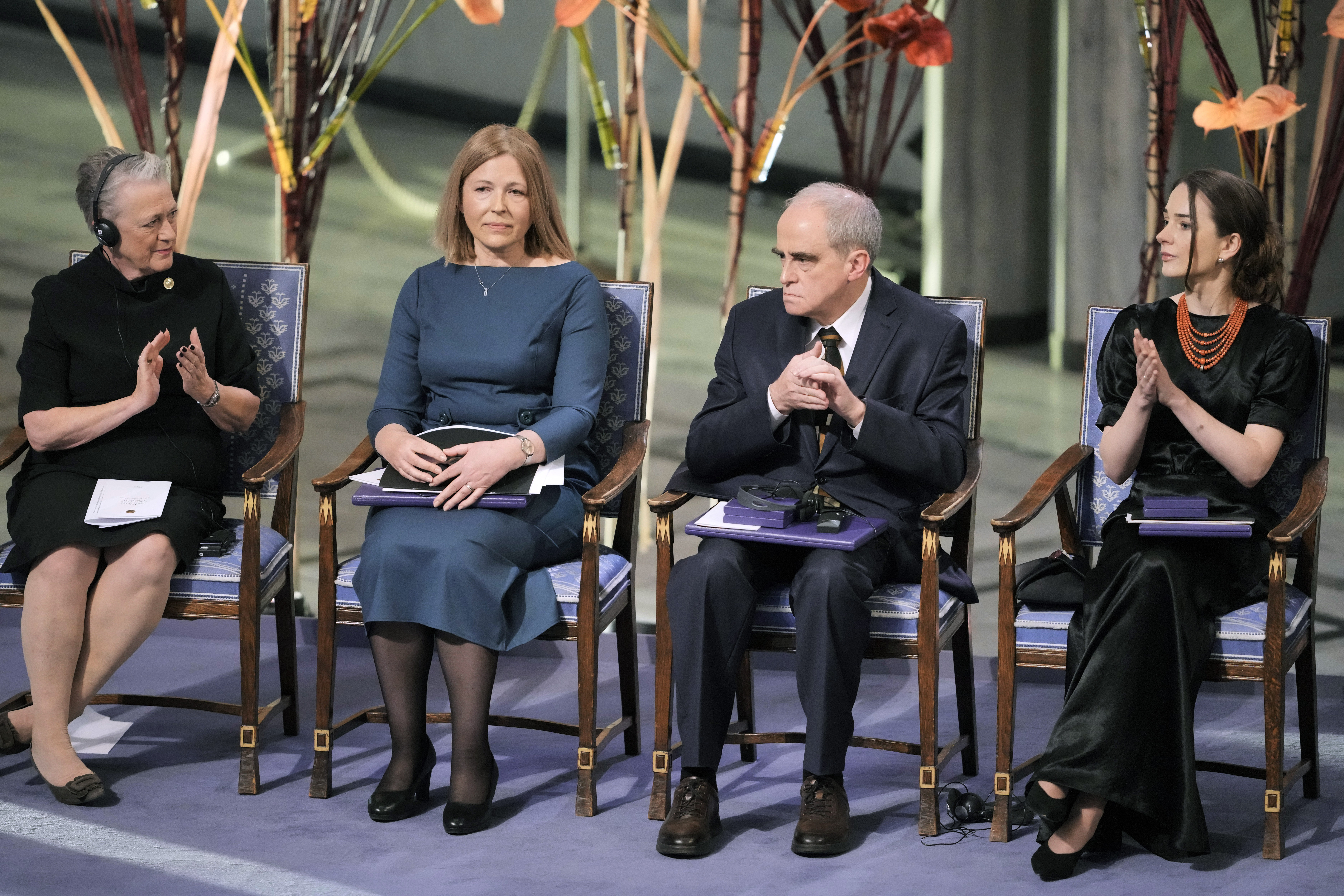 Berit Reiss-Andersen, Chair of the Nobel Committee, left, and representatives of the 2022 Nobel Peace Prize laureates, from second left: Natalia Pinchuk, the wife of Nobel Peace Prize winner Ales Bialiatski, Yan Rachinsky, chairman of the International Memorial Board and Oleksandra Matviychuk, head of the Ukraine's Center for Civil Liberties attend the Nobel Peace Prize ceremony, at Oslo City Hall, Norway, Saturday, Dec. 10.