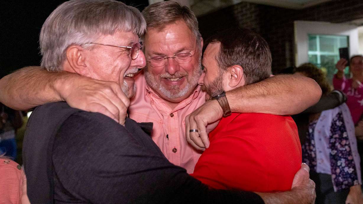 Lee Clark, right, embraces family and friends immediately after his release from Floyd County Jail. He and another Georgia man were exonerated of murder after spending 25 years in prison.