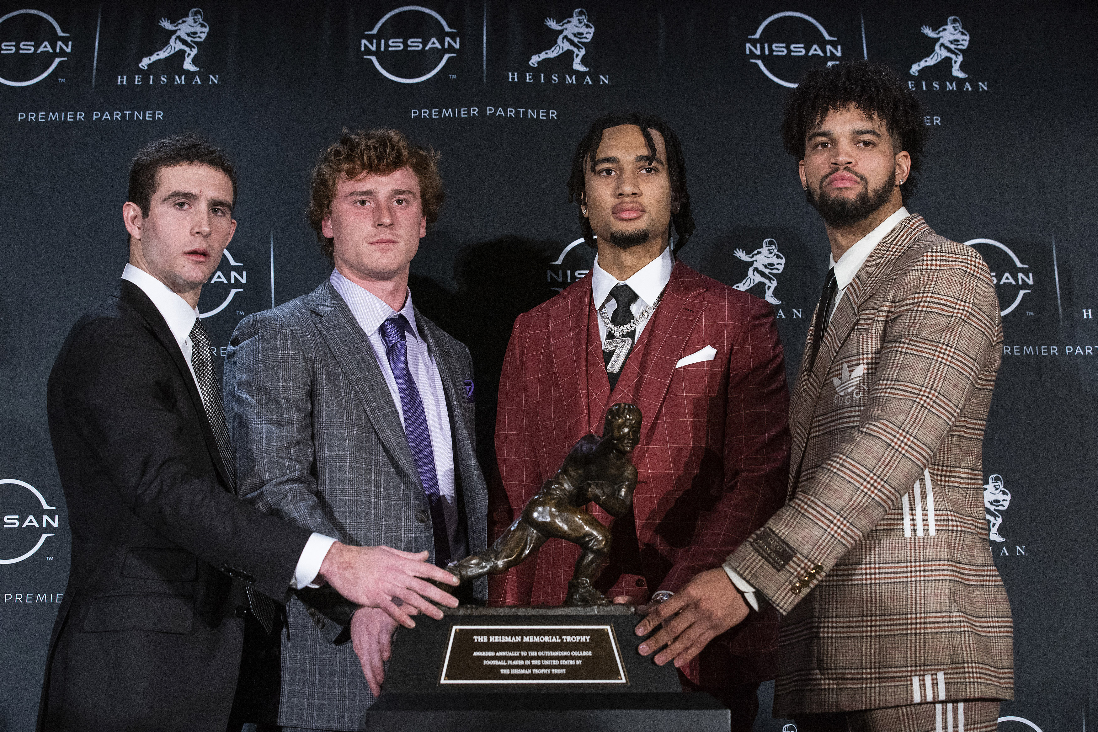 The Heisman trophy finalists, Georgia quarterback Stetson Bennett, TCU quarterback Max Duggan, Ohio State quarterback C.J. Stroud and Southern California quarterback Caleb Williams, from left, stand for a photo with the trophy before attending the award ceremony Saturday, Dec. 10, 2022, in New York. 