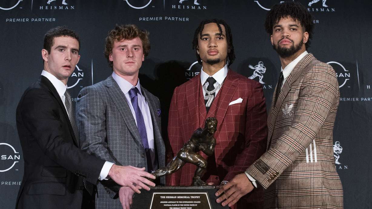 The Heisman trophy finalists, Georgia quarterback Stetson Bennett, TCU quarterback Max Duggan, Ohio State quarterback C.J. Stroud and Southern California quarterback Caleb Williams, from left, stand for a photo with the trophy before attending the award ceremony Saturday, Dec. 10, 2022, in New York.