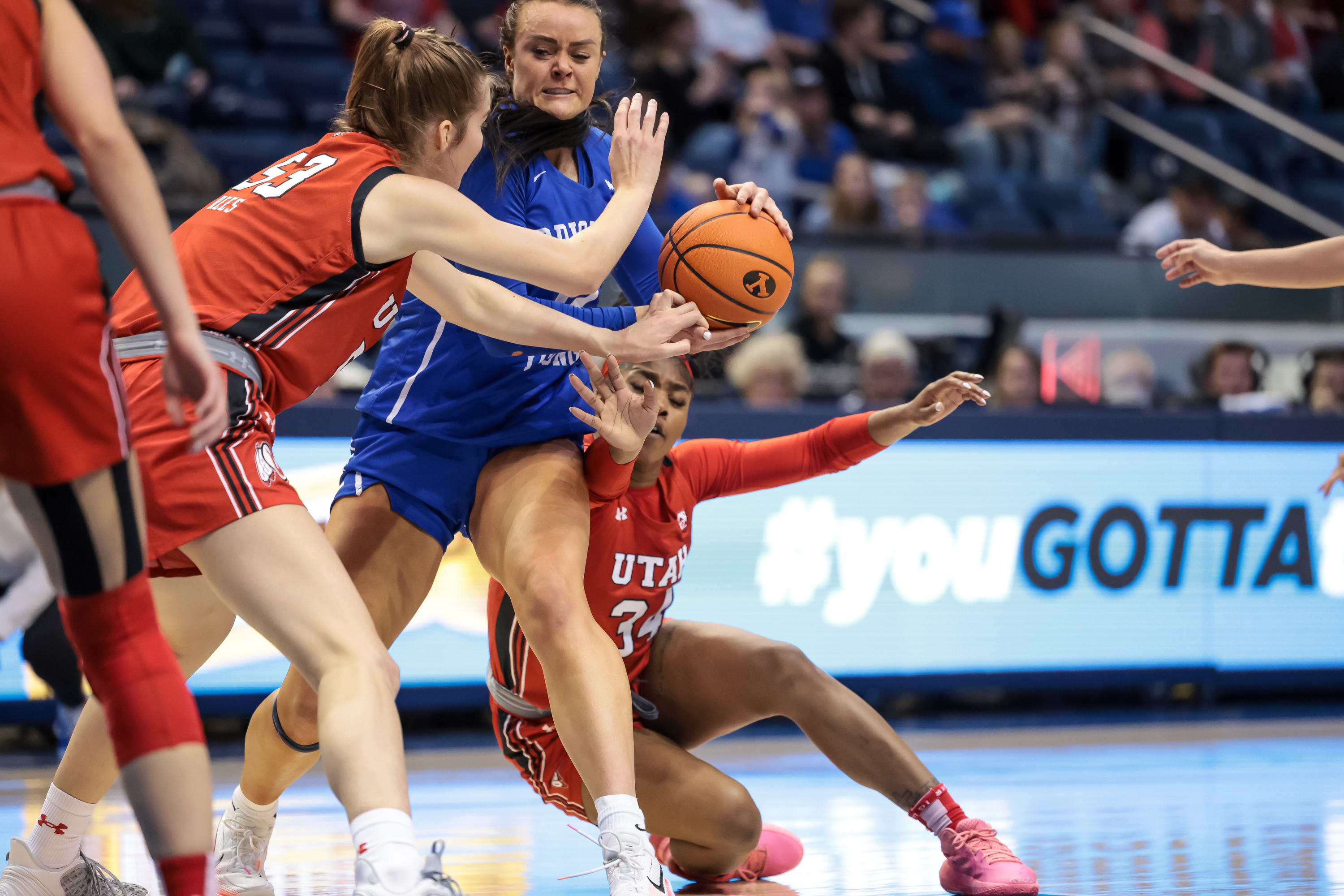 BYU forward Lauren Gustin (12) tries to move between Utah forward Kelsey Rees (53) and forward Dasia Young (34) during a game at the Marriott Center in Provo on Saturday, Dec. 10, 2022.