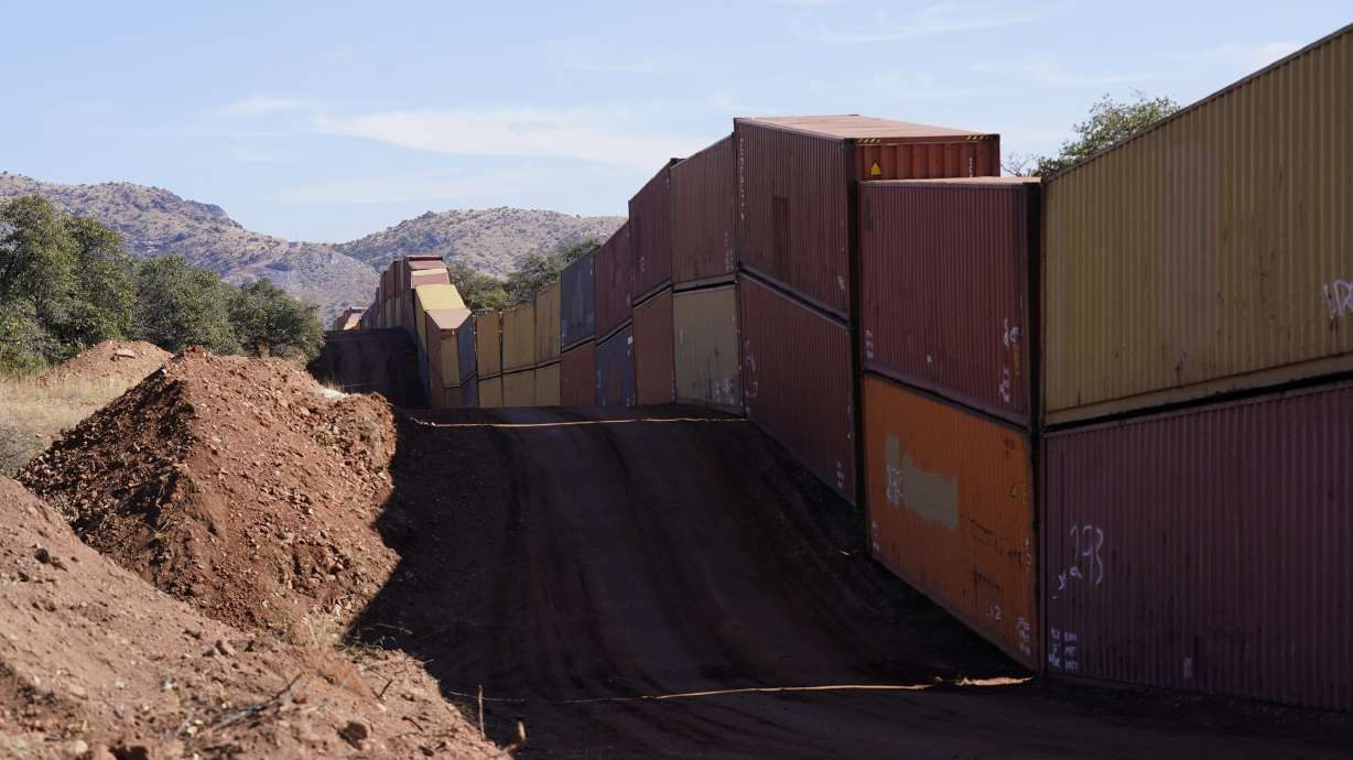 A long row of double-stacked shipping containers provide a new wall between the United States and Mexico in the remote section area of San Rafael Valley, Arizona, Dec. 8. Republican Gov. Doug Ducey made a bold show of border enforcement even as he prepares to step aside next month for Democratic Governor-elect Katie Hobbs.