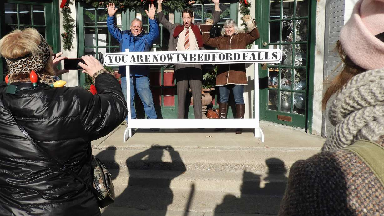 Joined by movie buffs, actor Brian Rohan, dressed as George Bailey, poses for photos during the It's a Wonderful Life Festival in Seneca Falls, New York, in 2017.