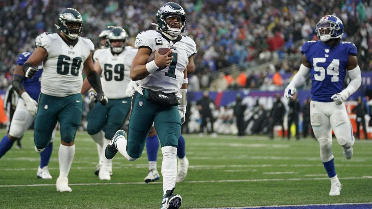 Philadelphia Eagles quarterback Jalen Hurts (1) scores a touchdown against the New York Giants during the third quarter of an NFL football game, Sunday, Dec. 11, 2022, in East Rutherford, N.J.