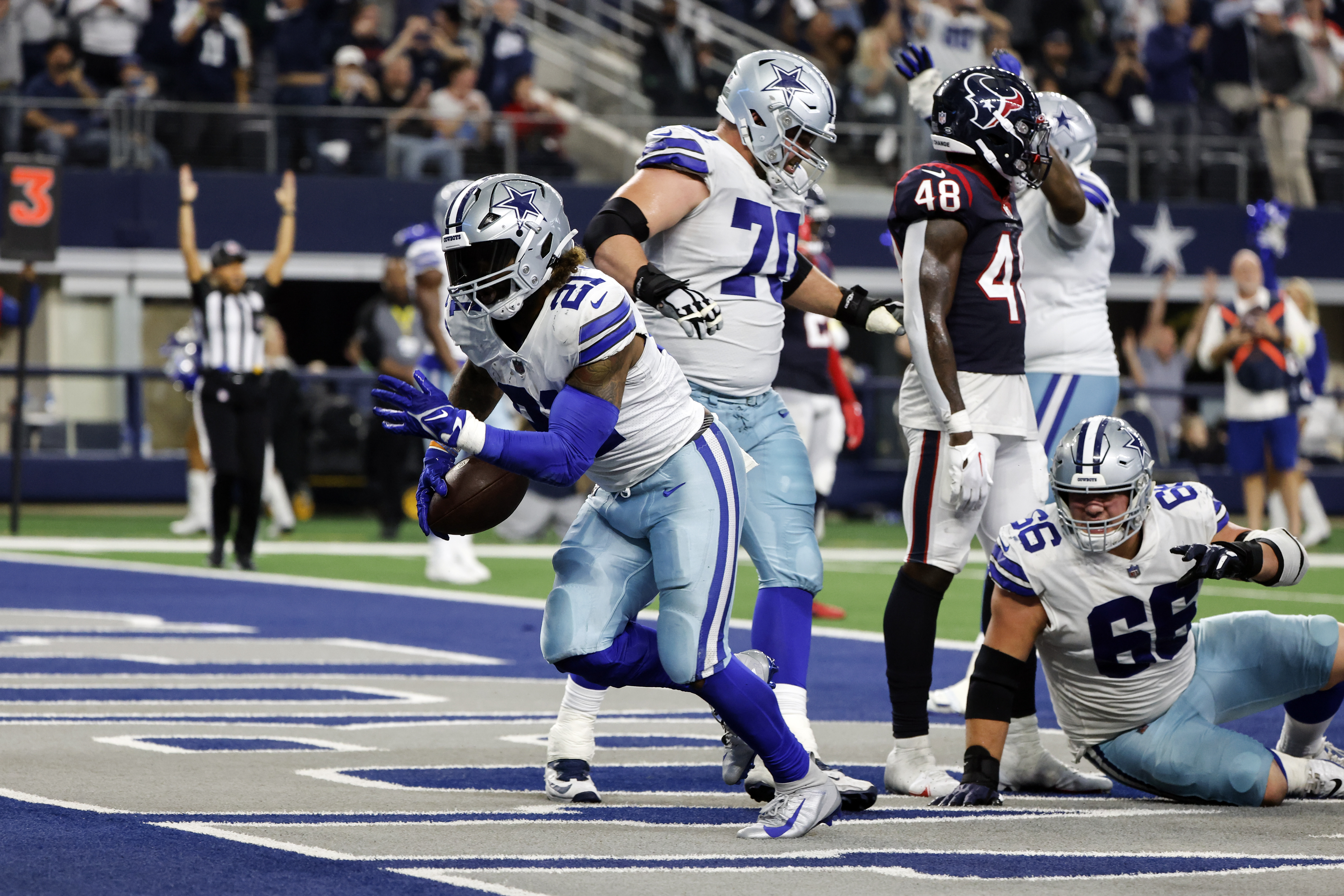 Dallas Cowboys running back Ezekiel Elliott (21) scores a touchdown during the second half of an NFL football game against the Houston Texans, Sunday, Dec. 11, 2022, in Arlington, Texas. 