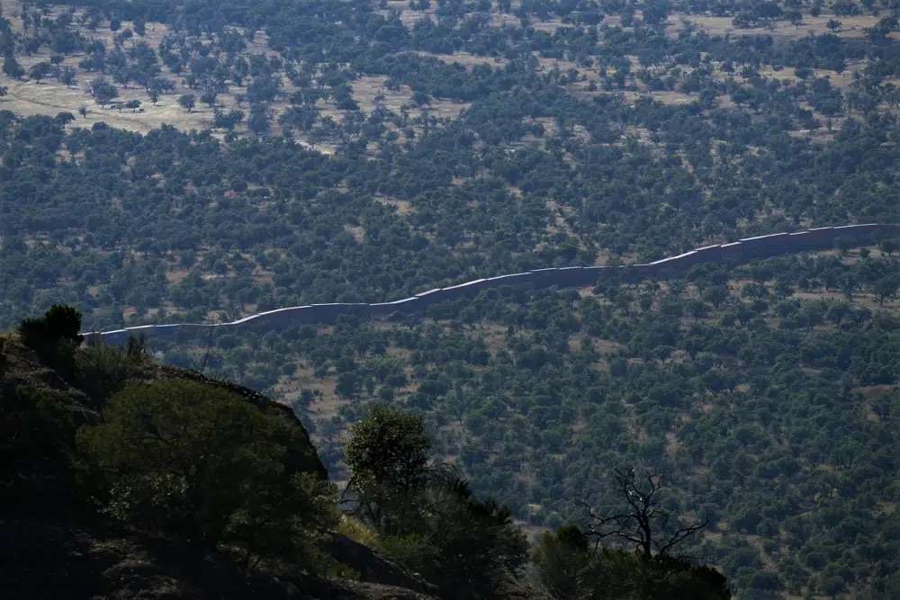 Newly installed shipping containers create a wall between the United States and Mexico in San Rafael Valley, Arizona, Dec. 8.