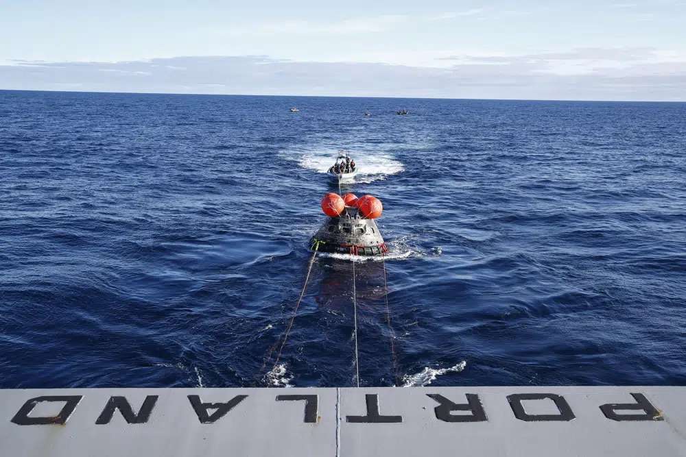 NASA's Orion capsule makes its way toward the U.S.S. Portland after being successfully secured by a NASA and U.S. Navy team in the Pacific off Mexico, Sunday concluding a 25-day test flight. The mission should clear the way for astronauts on the program’s next lunar flyby, set for 2024.