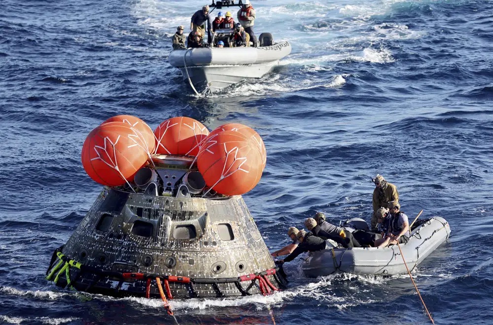 NASA's Orion capsule splashes down Sunday to conclude a dramatic 25-day test flight, as seen from aboard the U.S.S. Portland in the Pacific off Mexico. The mission should clear the way for astronauts on the program’s next lunar flyby in 2024.
