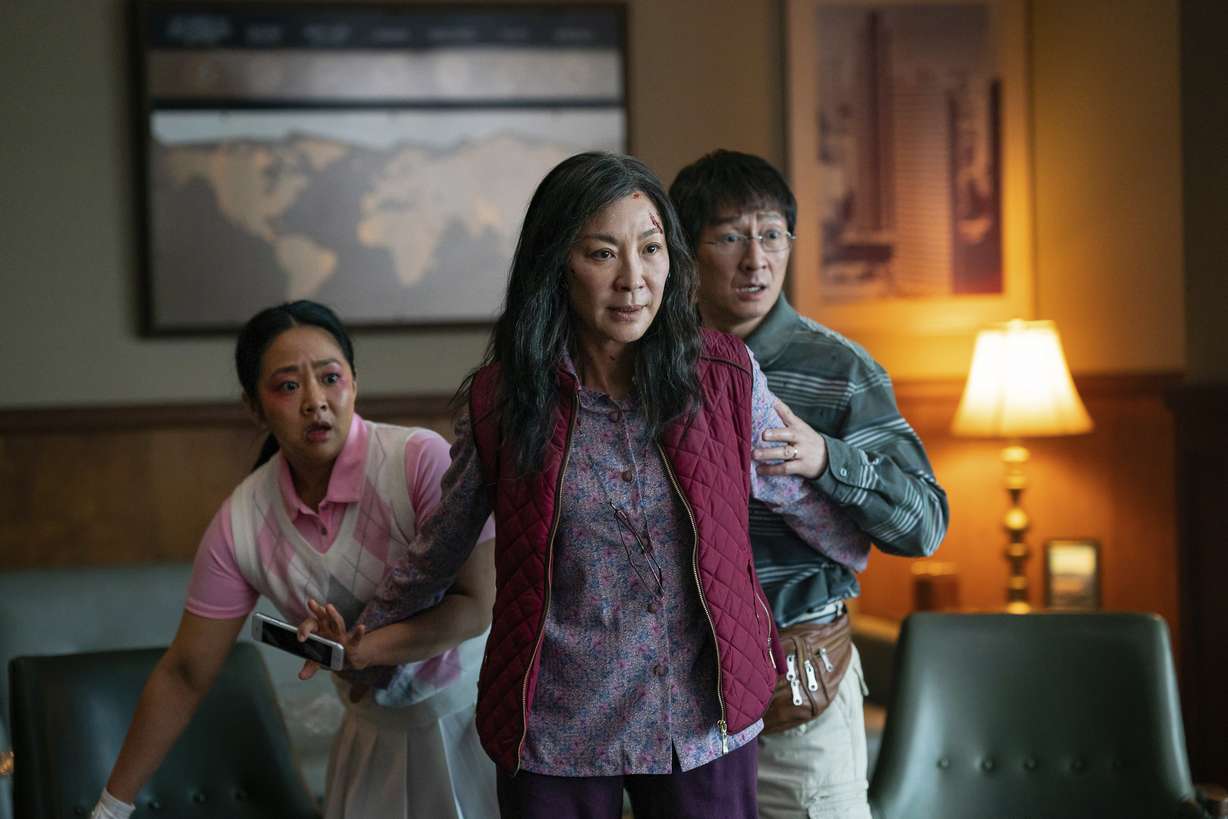 This image released by A24 Films shows, from left, Stephanie Hsu, Michelle Yeoh and Ke Huy Quan in a scene from, "Everything Everywhere All At Once."