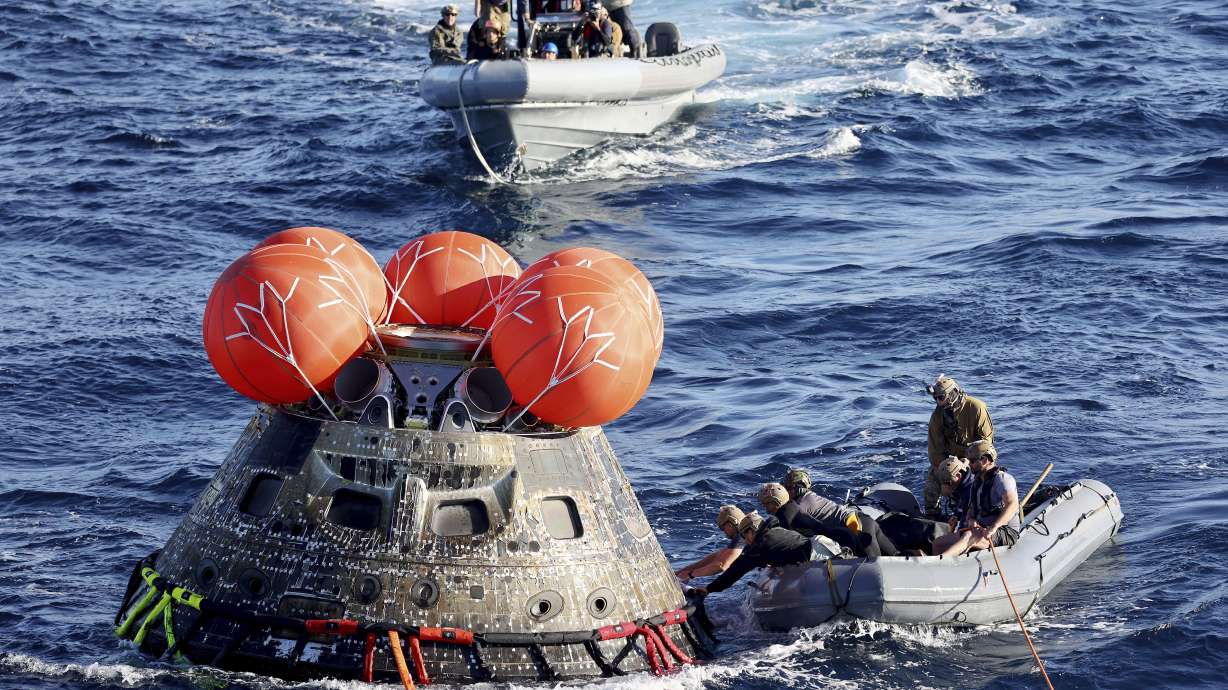 U.S. Navy divers secure NASA’s Orion capsule during recovery operations after it splashed down in the Pacific off the coast of Mexico, Sunday, Dec. 11, 2022, concluding a 25-day test flight. The mission should clear the way for astronauts on the program’s next lunar flyby, set for 2024.